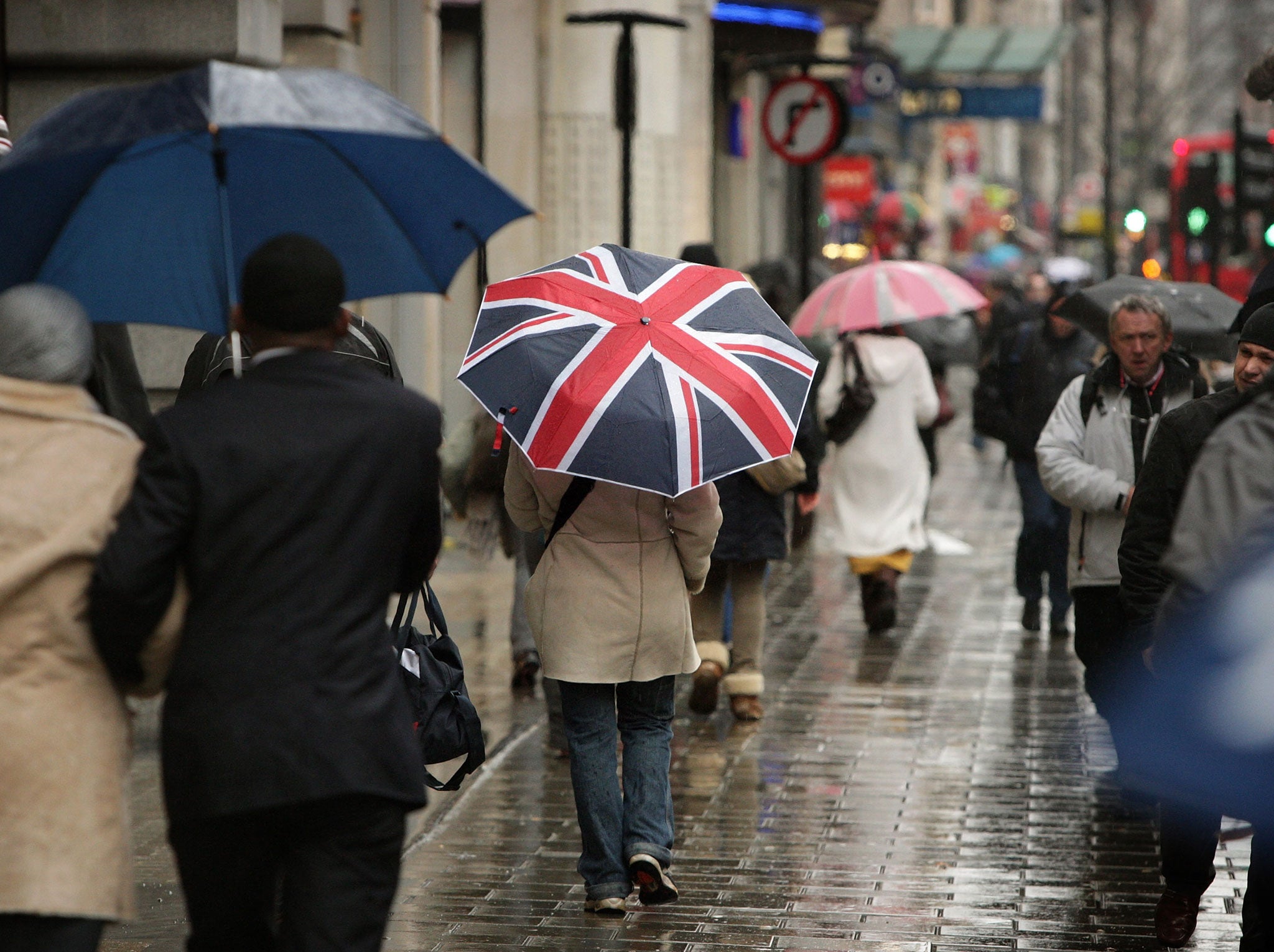 A woman holding a Union Flag umbrella walks along Oxford Street in the rain on January 23, 2009 in London, England.