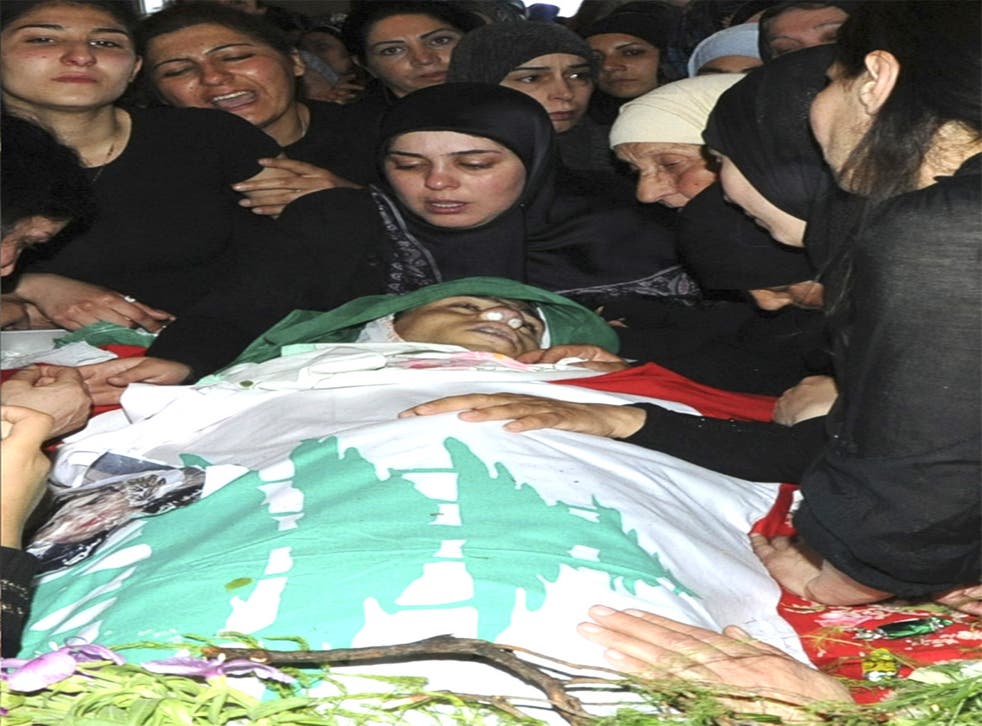 Relatives of one of the Lebanese soldiers killed at a checkpoint mourning at his funeral
