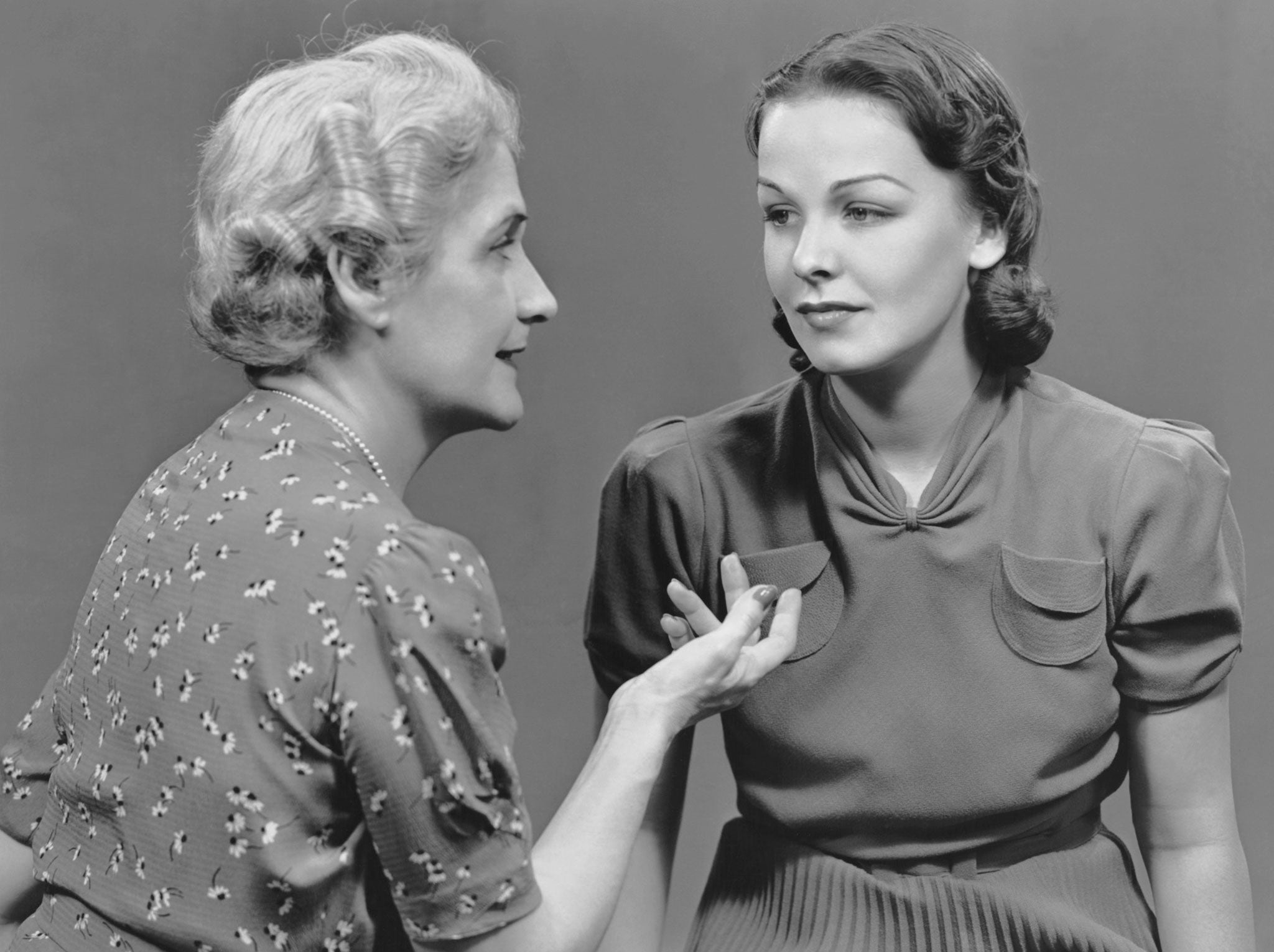 UNITED STATES - CIRCA 1950s: Mother talking with adult daughter.