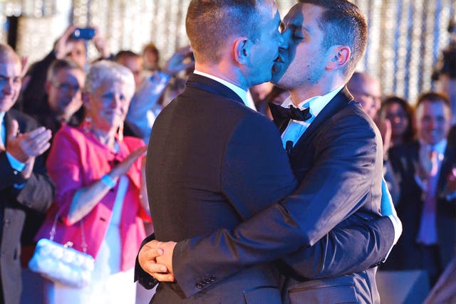 Vincent Autin, left, and Bruno Boileau kiss at France’s first official gay marriage in Montpellier
