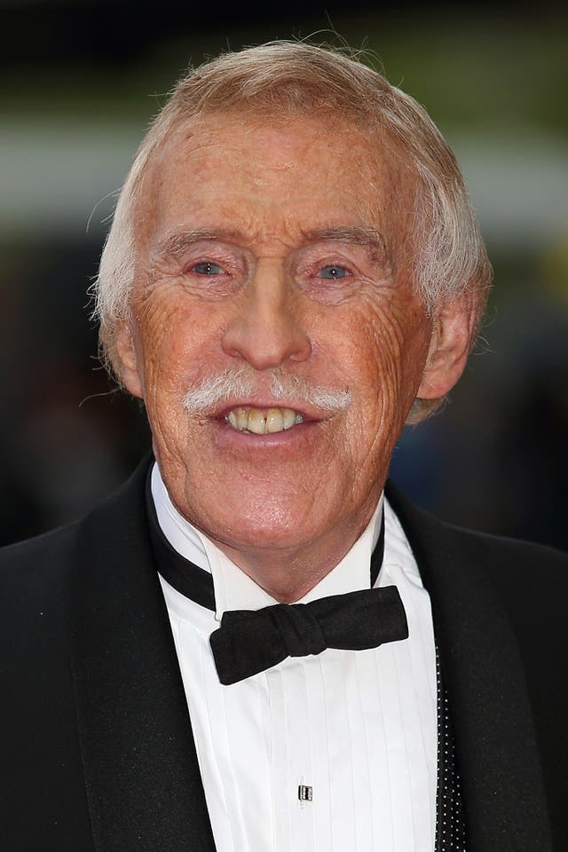 English TV host Sir Bruce Forsyth poses on the red carpet as he arrives at the British Academy Television Awards in London on May 12, 2013