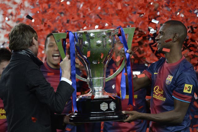 Tito Vilanova (L) and Eric Abidal life the league trophy during a ceremony at the Camp Nou 