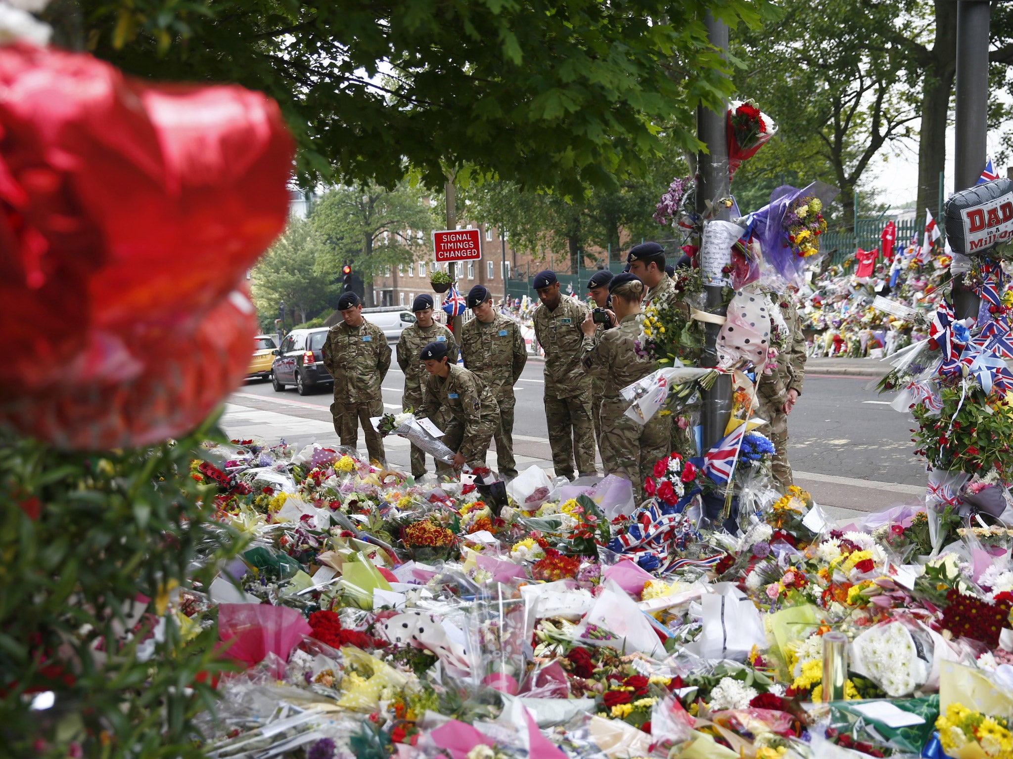 31 May 2013: Soldiers lay flowers at the scene of the killing of British soldier Lee Rigby in Woolwich, southeast London. The inquest into Rigby's death was opened and adjourned.