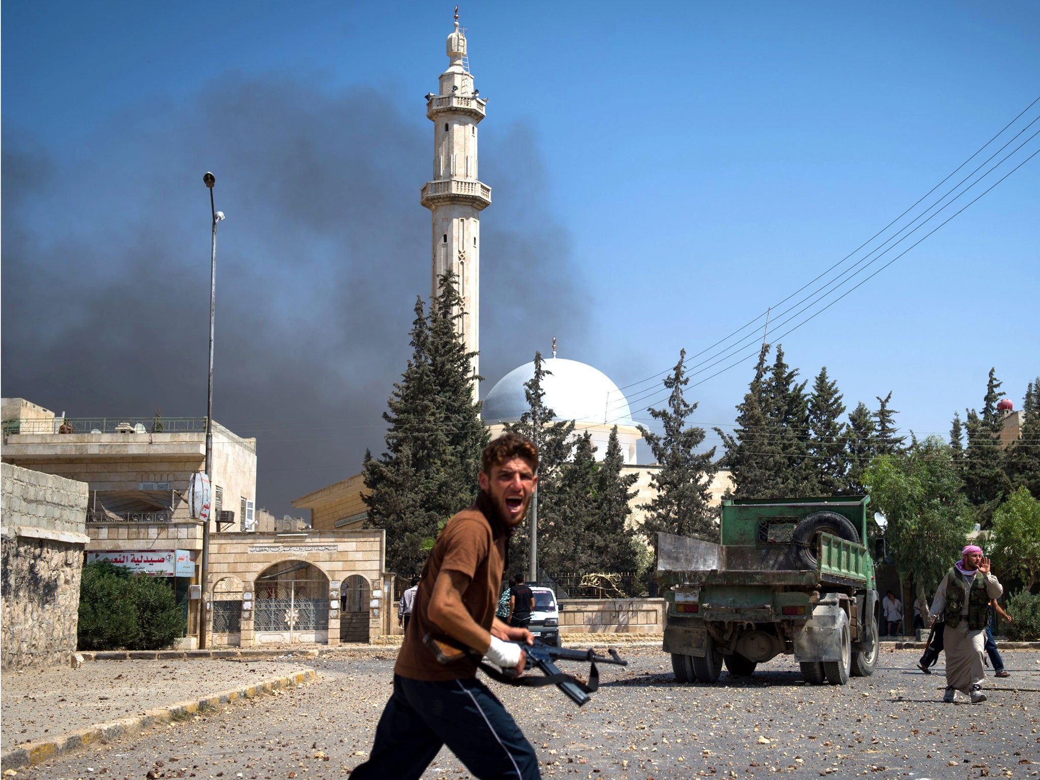 A fighter reacts to an airstrike in Aleppo in August last year