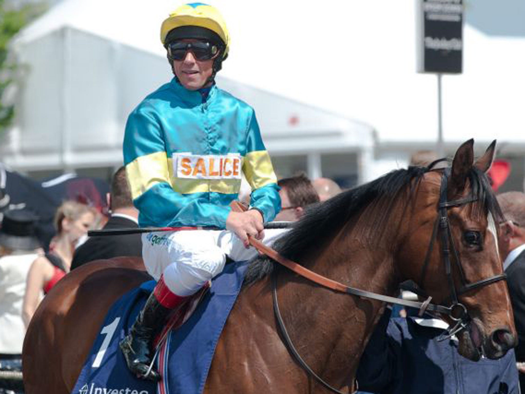 Italian Jockey Frankie Dettori, returning to racing after completing a six month ban for testing positive for cocaine, rides his mount in the paddock before the second race, The Investec Wealth and Investment stakes at Epsom