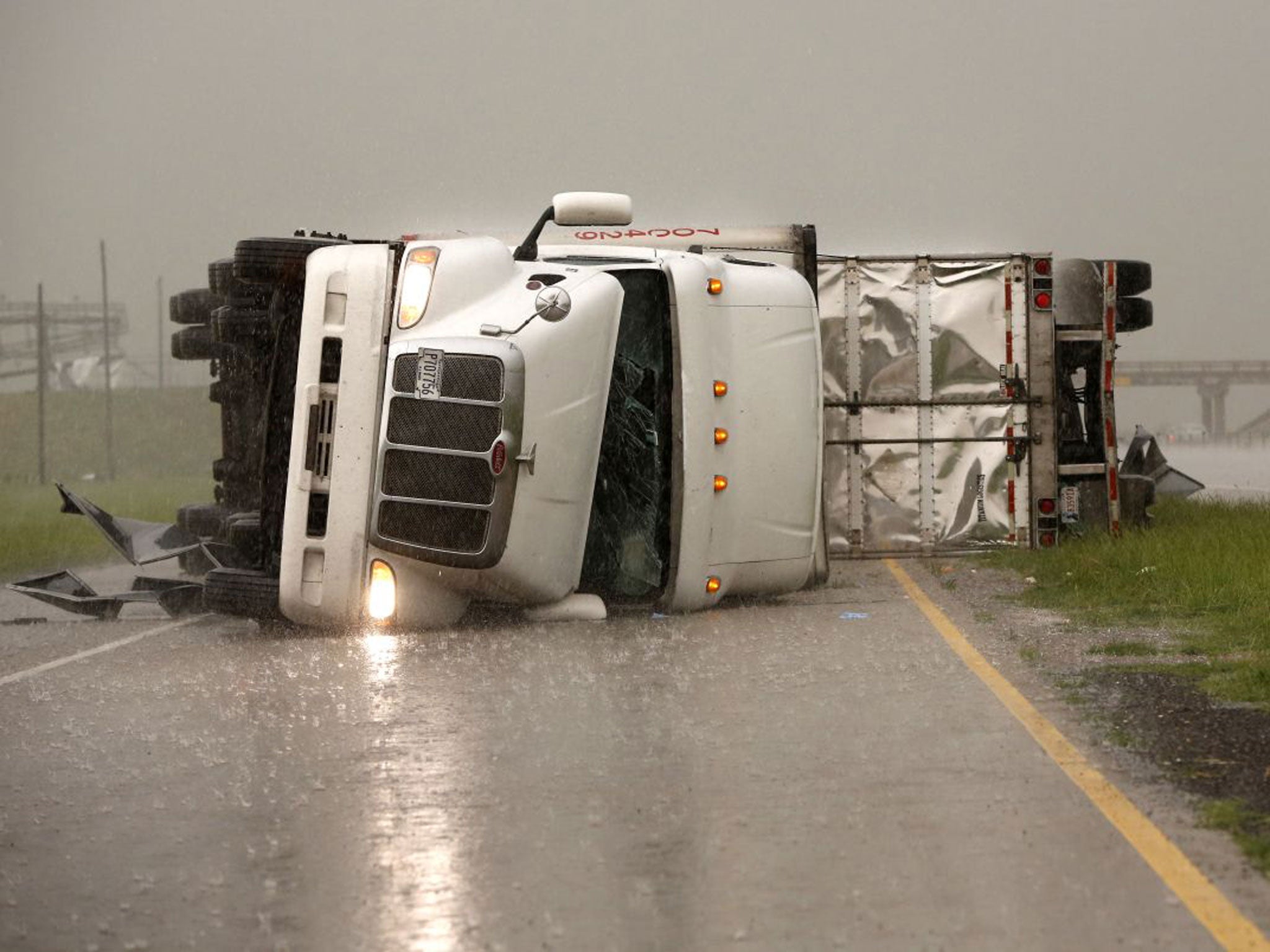 Overturned trucks block a road east of 81 in El Reno