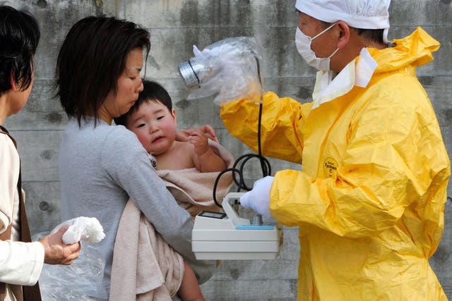 A child is tested for radiation after the accident in March 2011