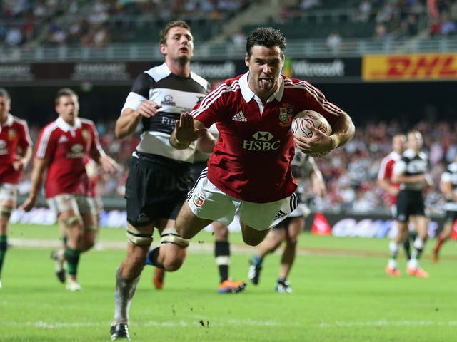 Tongue lashing: Mike Phillips scores a mouthwatering second try as the Lions open their summer tour with a 59-8 thrashing of the Barbarians in Hong Kong yesterday