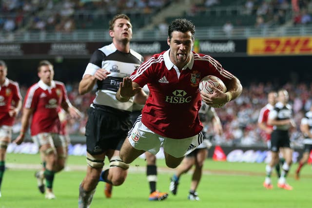 Tongue lashing: Mike Phillips scores a mouthwatering second try as the Lions open their summer tour with a 59-8 thrashing of the Barbarians in Hong Kong yesterday