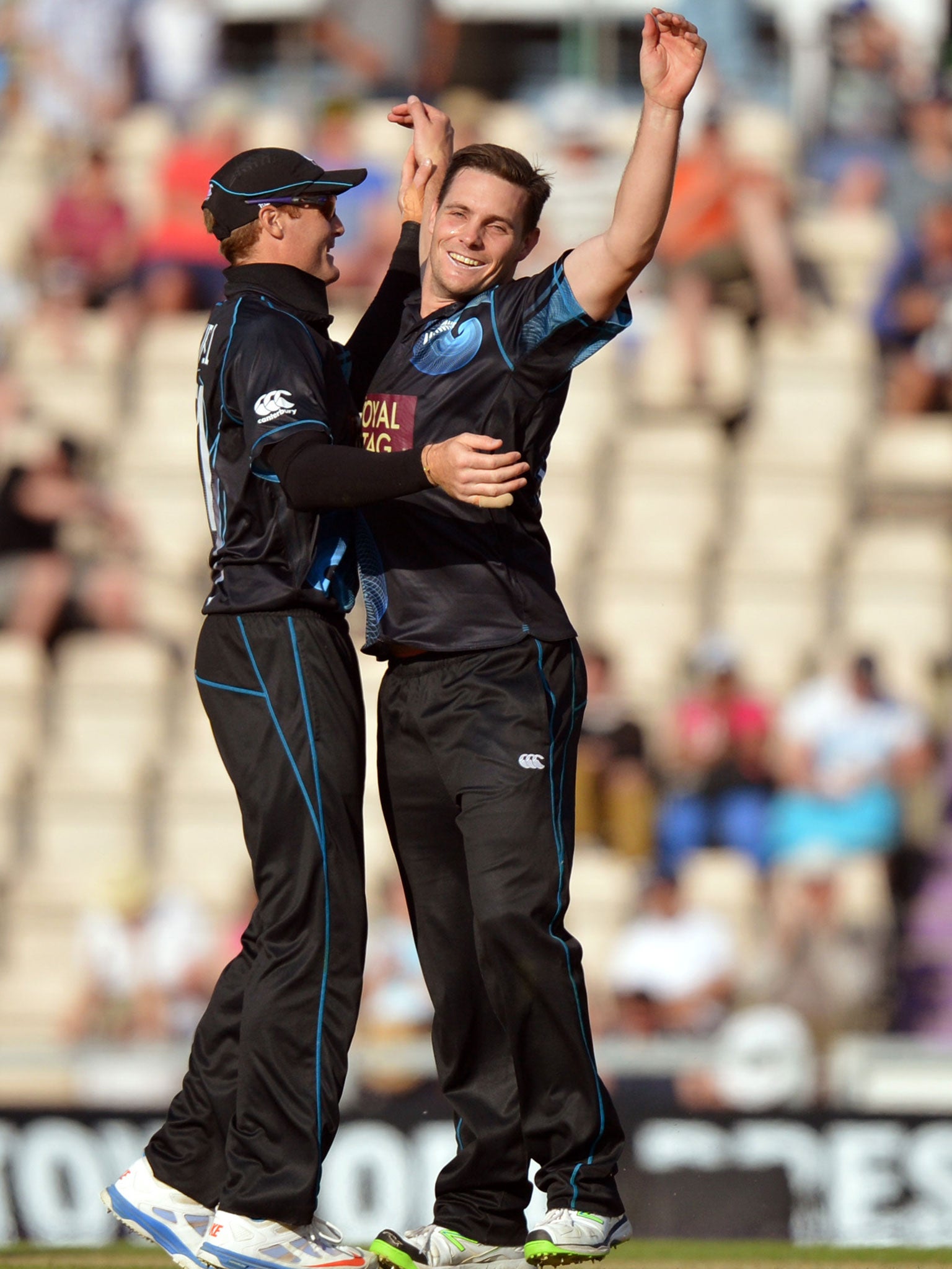 Mitchell McClenaghan, right, takes the wicket of Jade Dernbach
