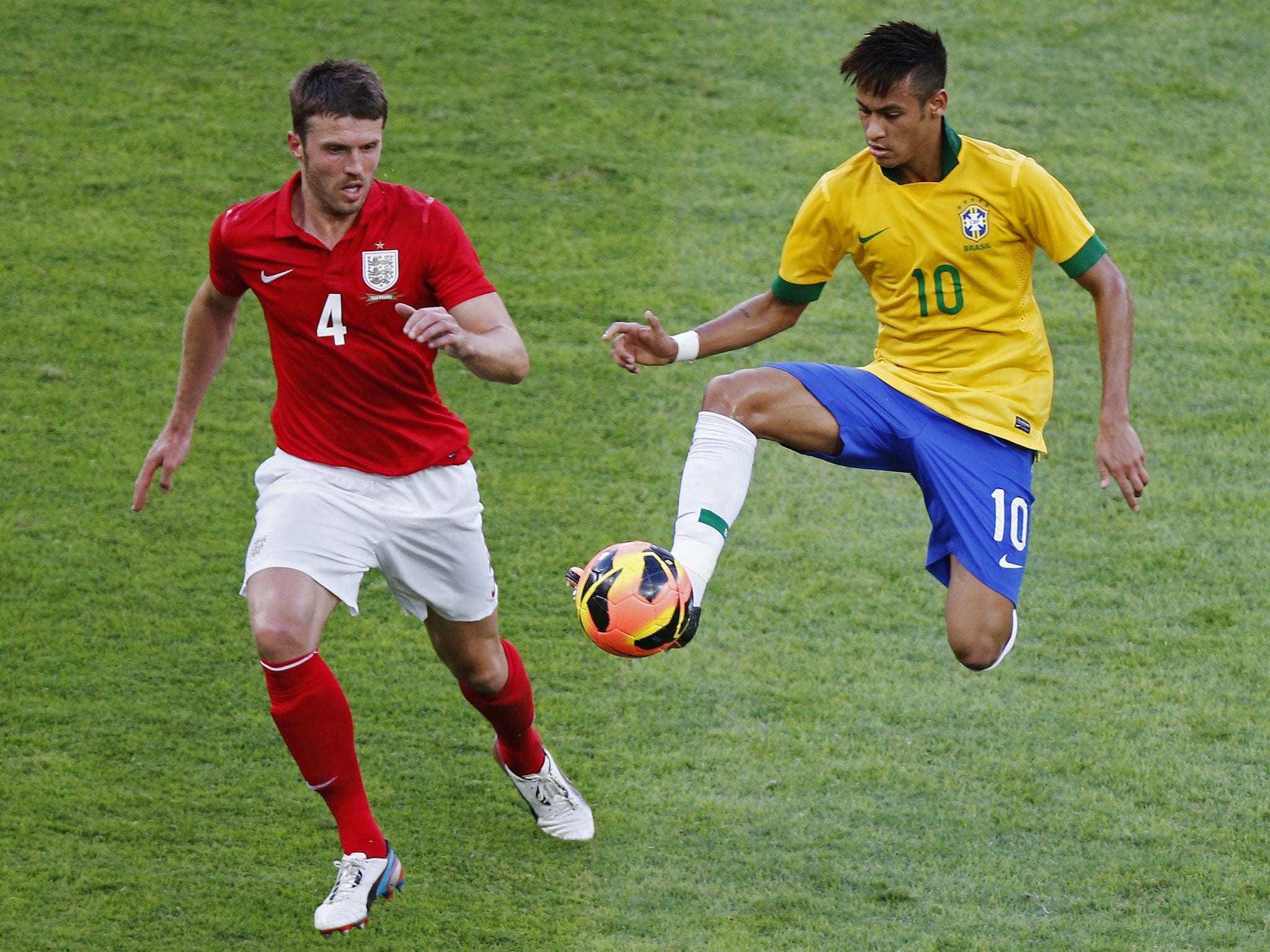 Brazil’s Neymar, right, takes the ball away from Michael Carrick, left