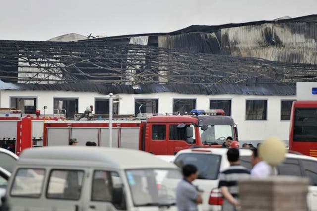 Rescue workers and fire trucks are seen outside a site of a fire, at a poultry slaughterhouse in Dehui, Jilin