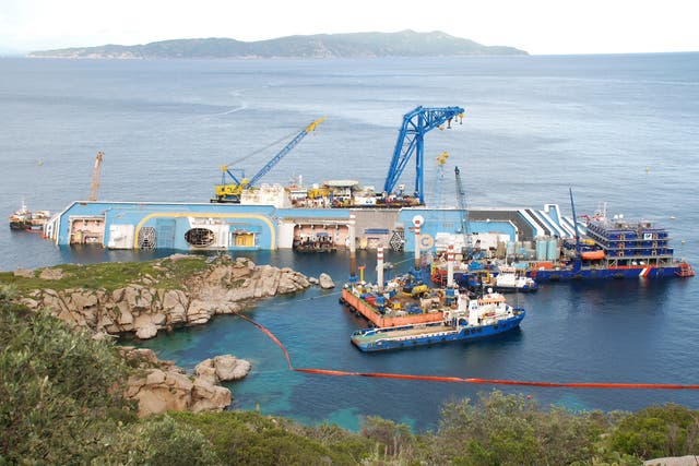 Cranes, tugs, platforms and a ship that houses what looks like a giant stack of Portakabins (furthest right) are all dwarfed by the wreckage of the Costa Concordia, the 290m cruise ship that sank in January 2012 on the coast of Giglio, off the Italian coast of Tuscany