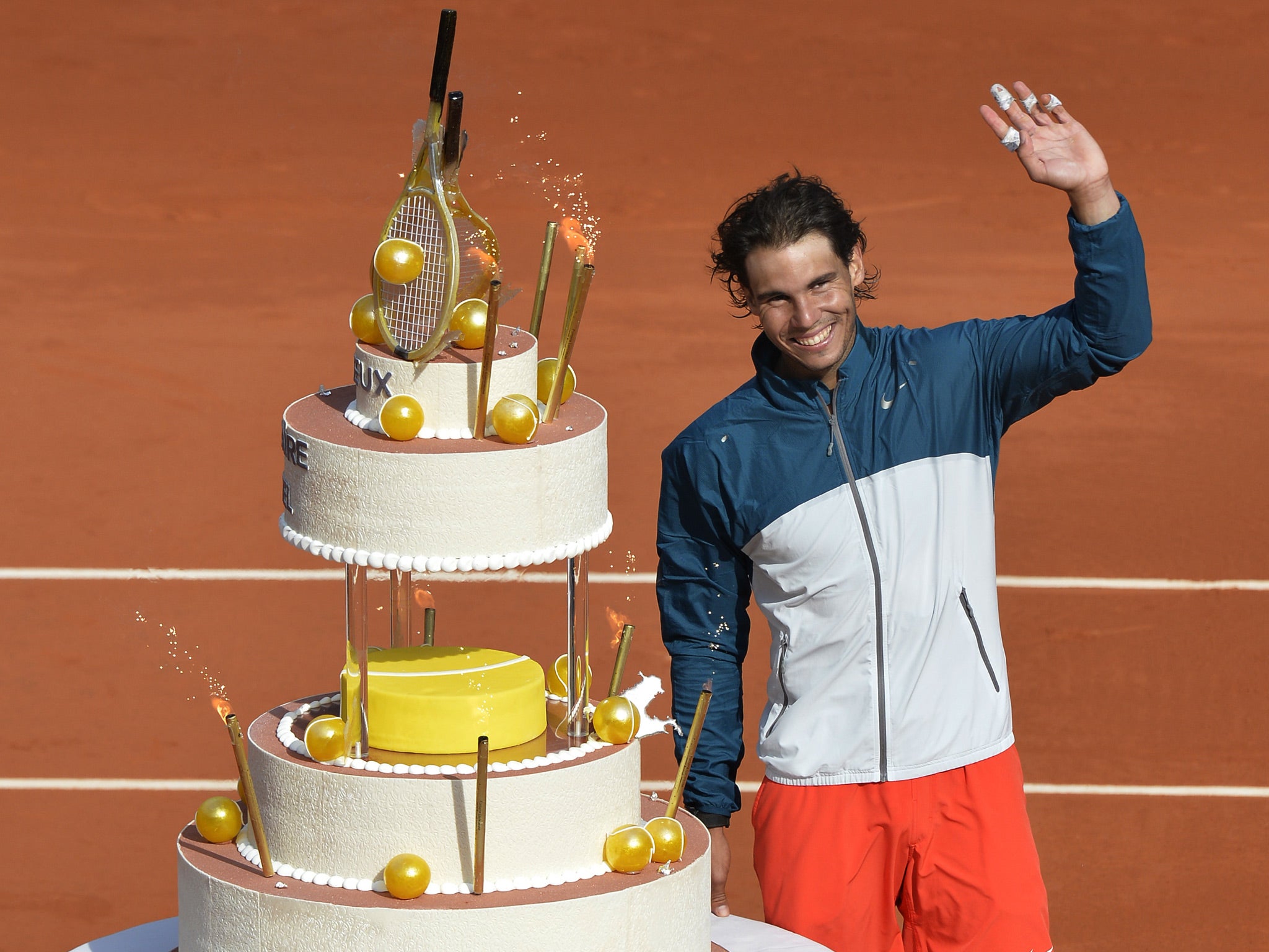 Spain's Rafael Nadal poses with his birthday cake after winning his French tennis Open round of 16 match at the Roland Garros