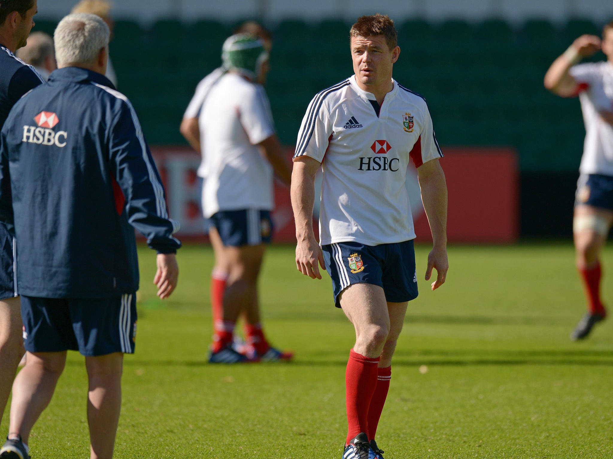 Brian O'Driscoll (C) of the British and Irish Lions rugby team speaks to coach Warren Gatland (L) during the captain's run in Perth on June 4, 2013