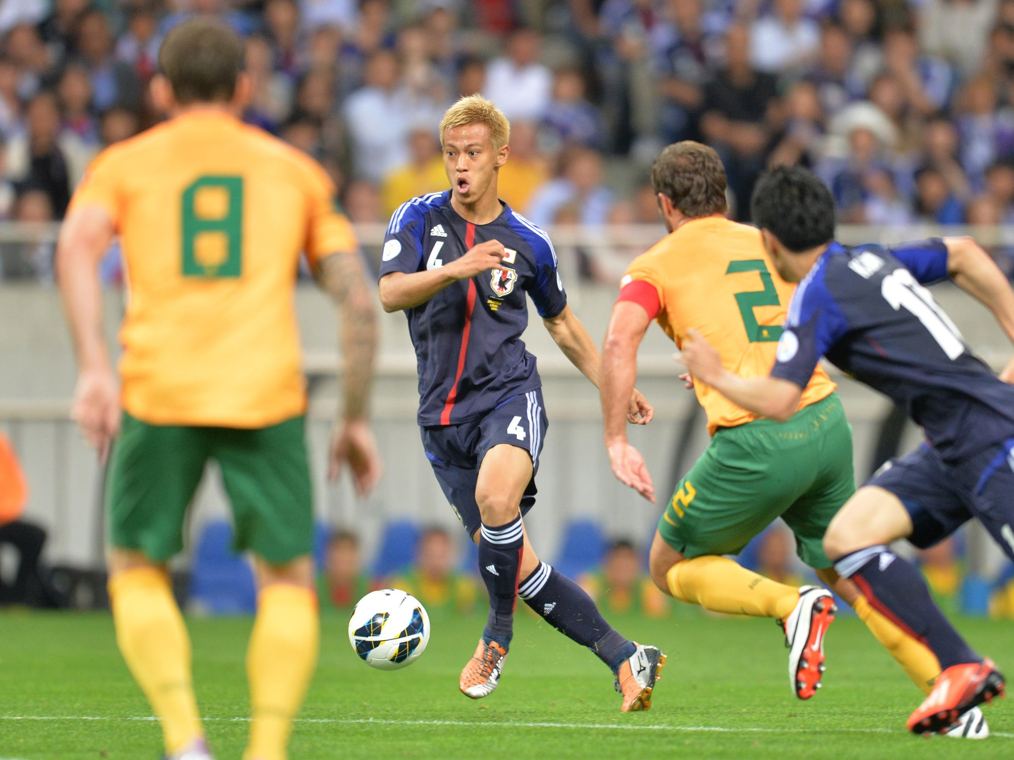 Japan's Keisuke Honda keeps the ball against Australia during the Asian final qualifying round for the 2014 World Cup. Japan drew 1-1 to qualify for next summer's tournament