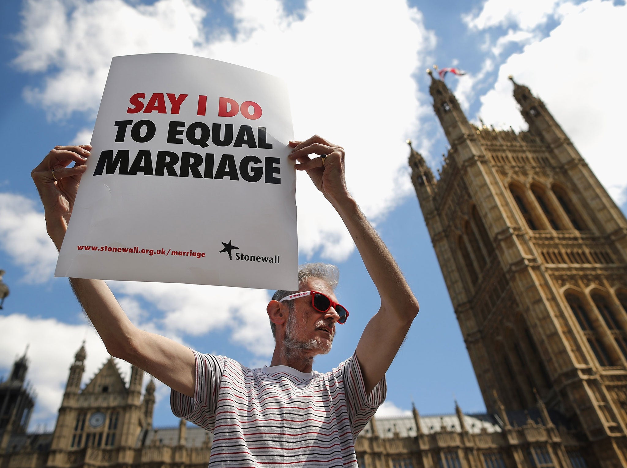 Not all gay people are good at art, as this criminally drab sign demonstrates: A proponent of same sex marriage protest outside the Houses of Parliament on June 3, 2013 in London, England.