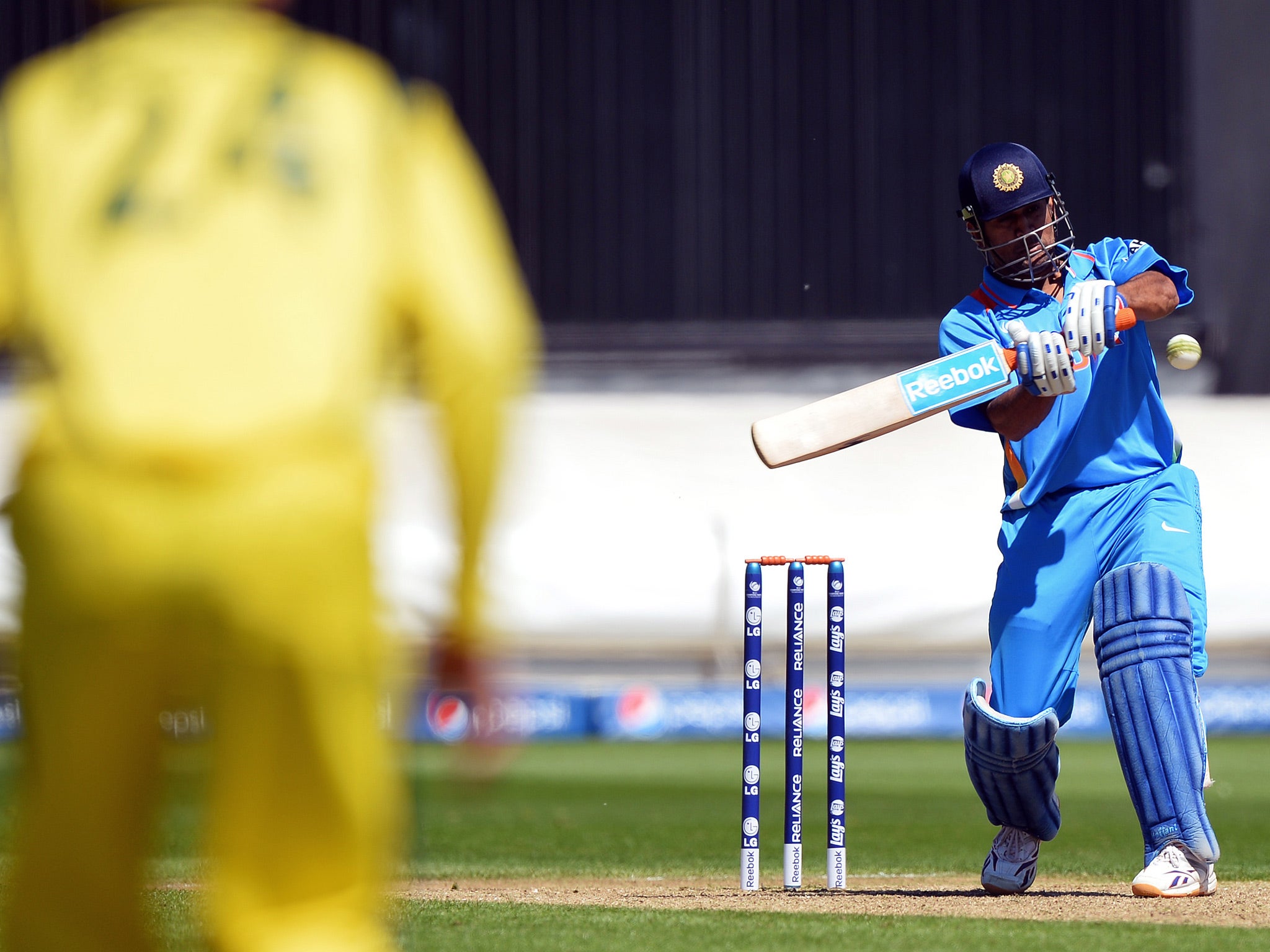 India's captain Mahendra Singh Dhoni plays a shot during the warm-up cricket match ahead of the 2013 ICC Champions Trophy between India and Australia at The Cardiff Wales Stadium
