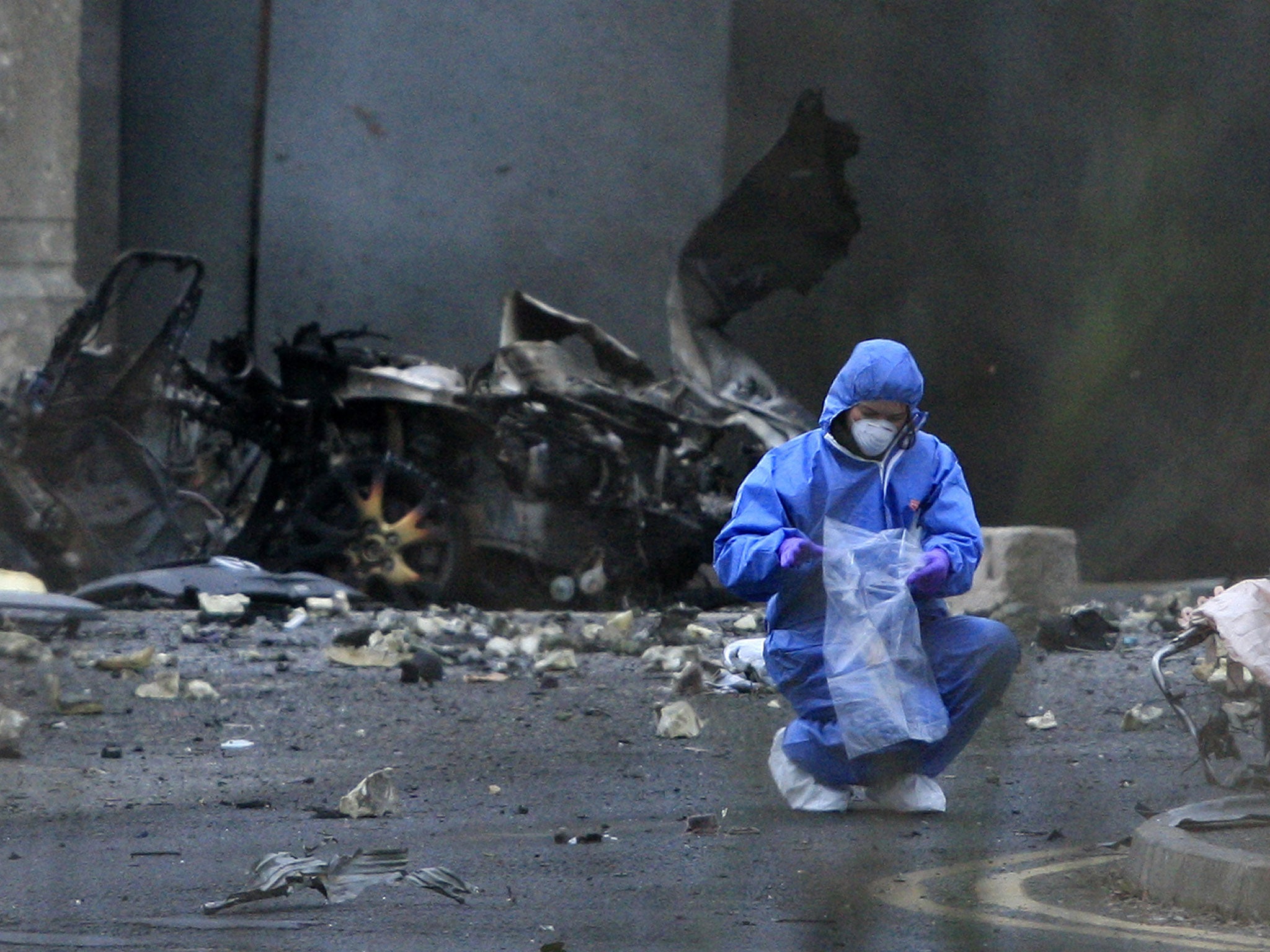 A forensics officer outside Newry courthouse after a car bomb attack in February 2010 that was blamed on dissident republicans