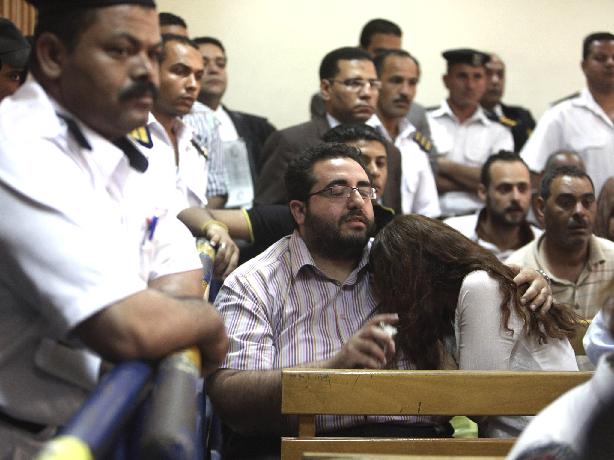 Friends of Egyptian suspects react as they listen to the judge's verdict