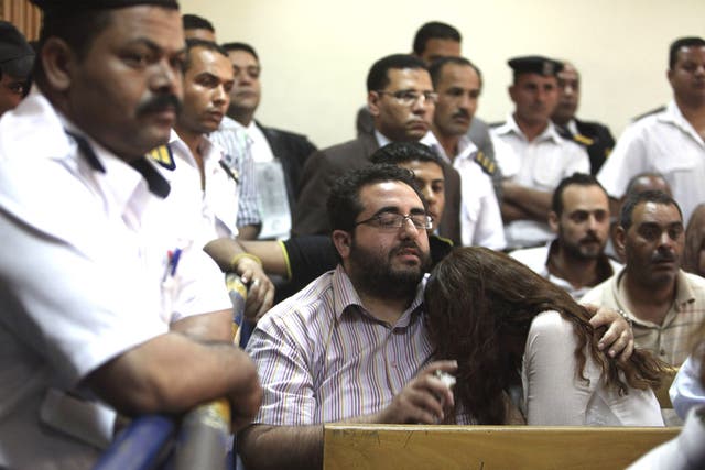 Friends of Egyptian suspects react as they listen to the judge's verdict