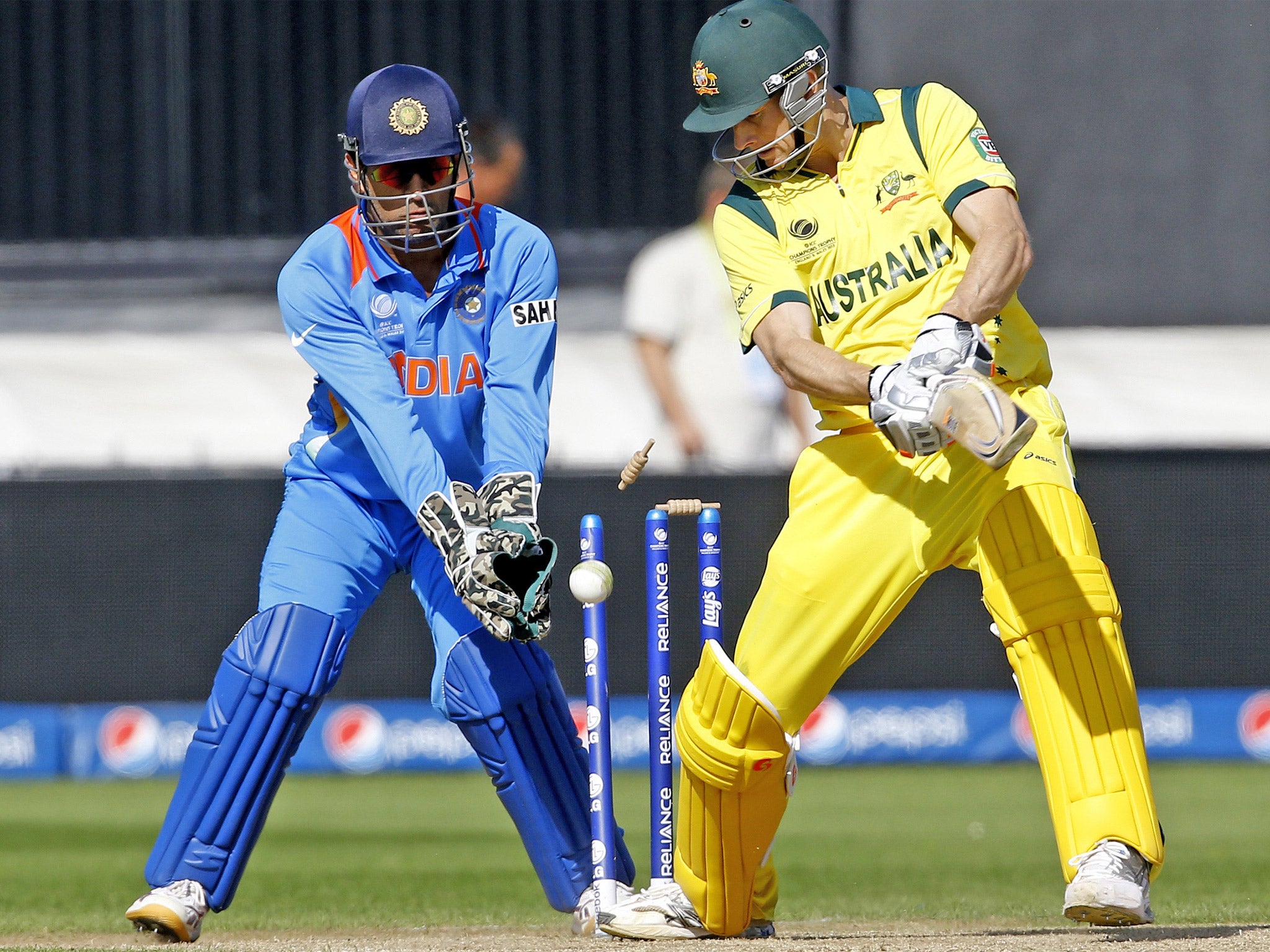 M S Dhoni looks on as Australia’s Adam Voges is bowled by R Ashwin