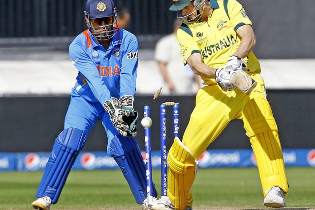 M S Dhoni looks on as Australia’s Adam Voges is bowled by R Ashwin