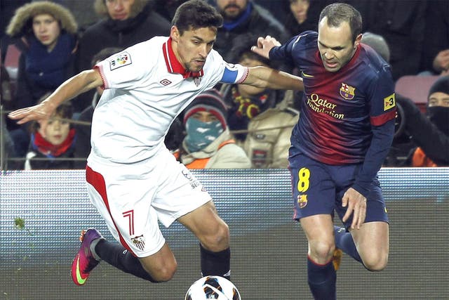Jesus Navas takes on Andres Iniesta of Barcelona in his Sevilla days