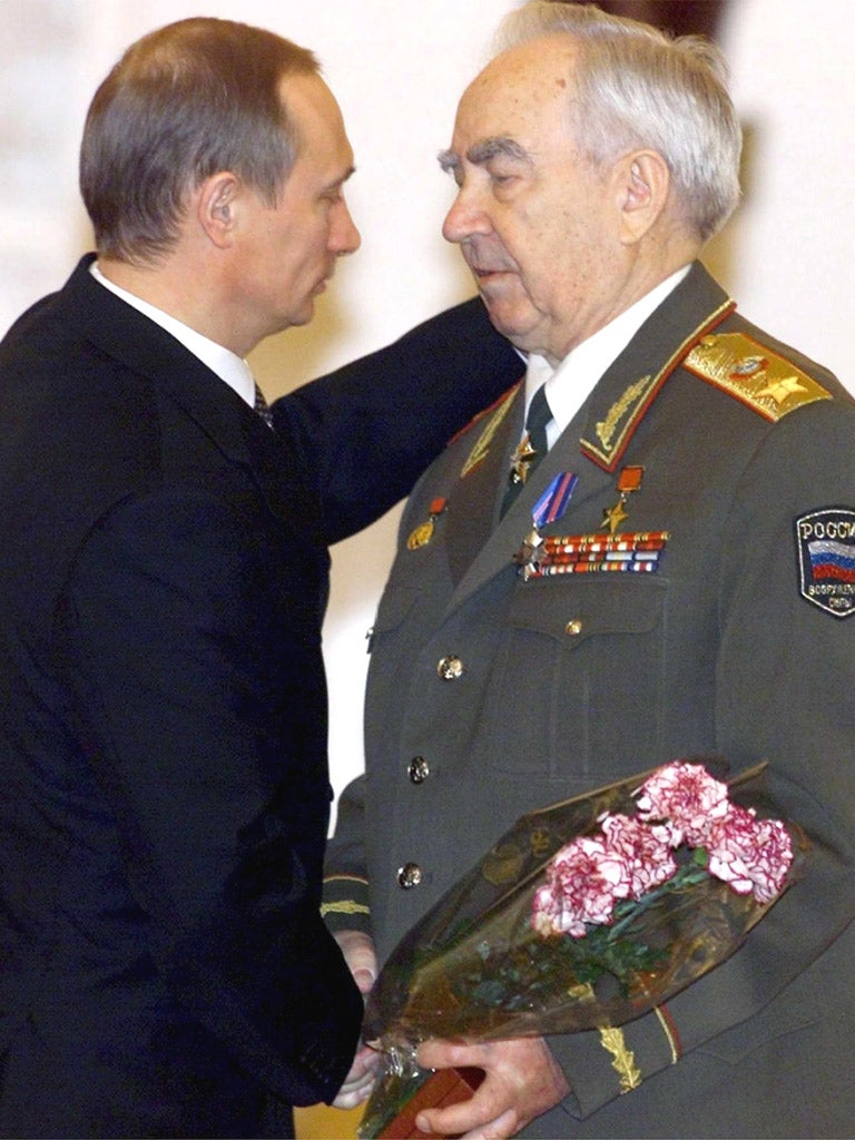 Viktor Kulikov, right, is congratulated by then Russian acting President Vladimir Putin at a ceremony marking Defender of the Fatherland Day, at the Kremlin in 2000