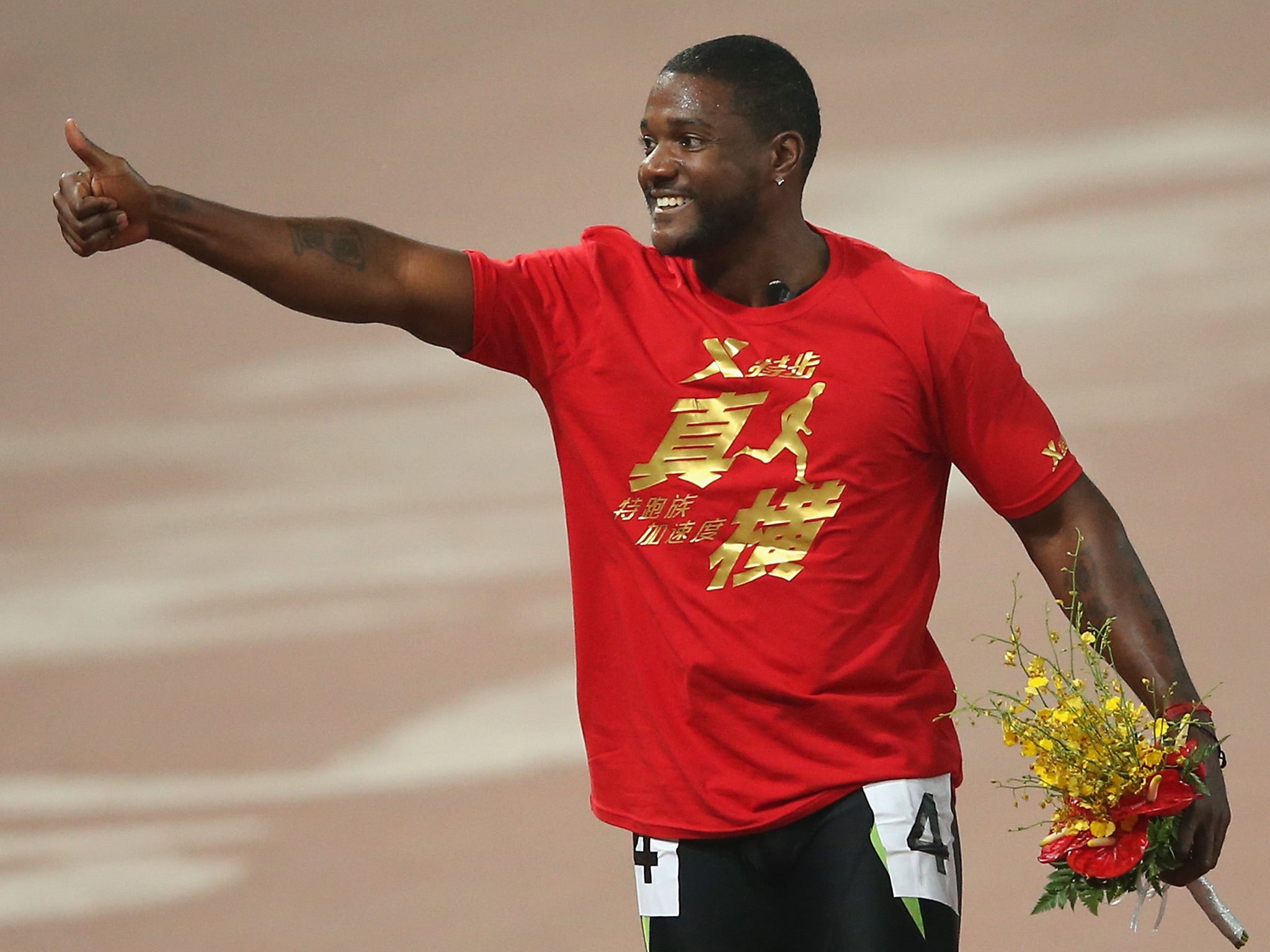 Justin Gatlin of United States celebrates after he won the Men's 100 Metres at National Stadium, also known as Bird's Nest, during 2013 IAAF World Challenge Beijing