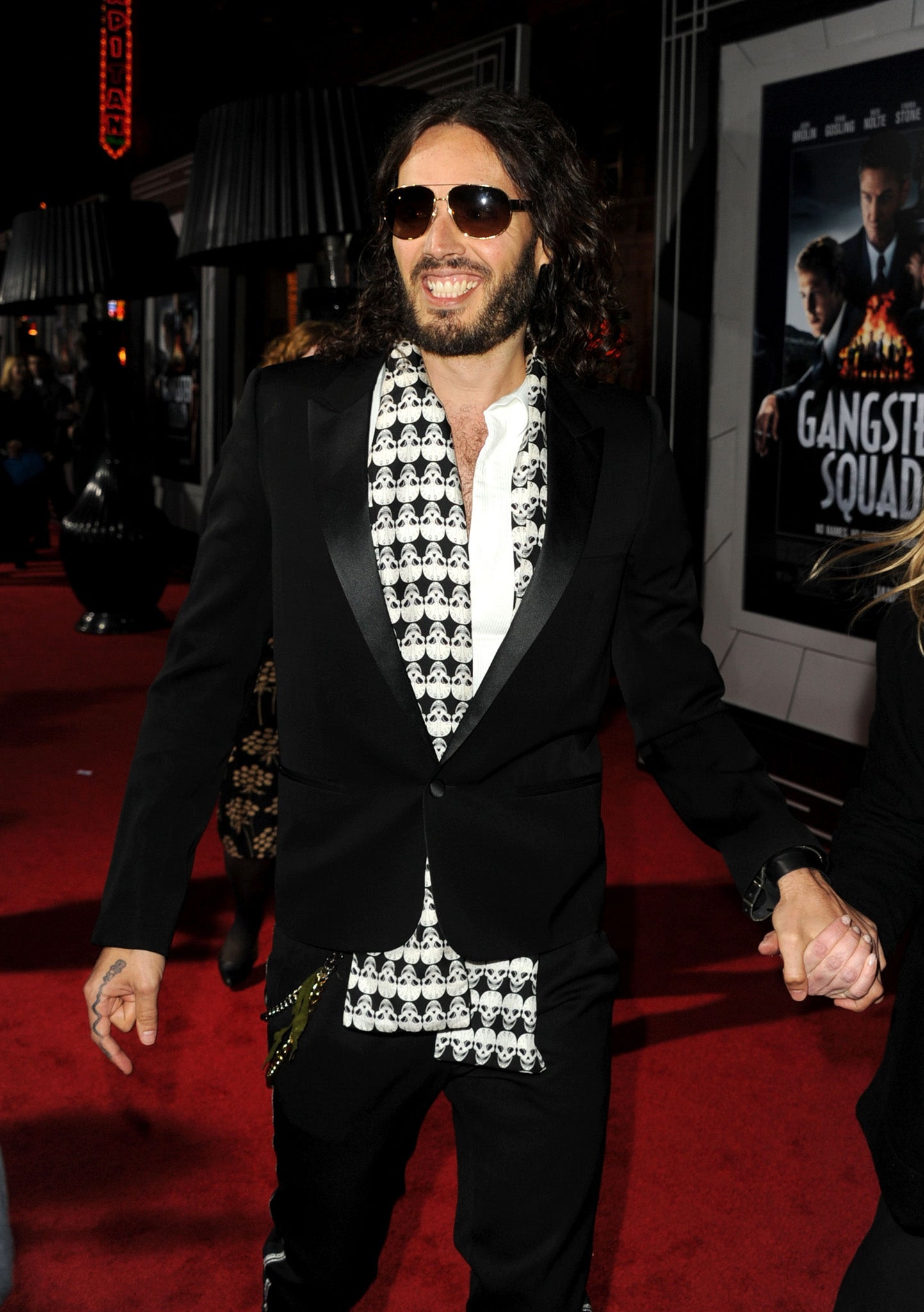 Russell Brand gives his best Doctor Who impression in a scarf and dark glasses at a recent film premiere.