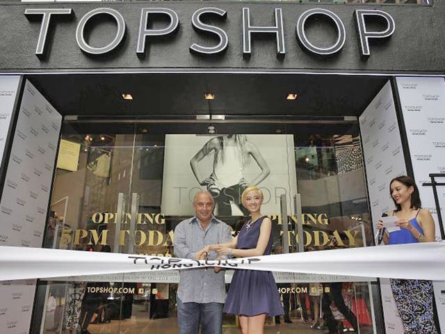 Sir Philip Green the owner of Topshop and Taiwanese actress Gwei Lun Mei cut a ribbon to mark the opening of the new Topshop store