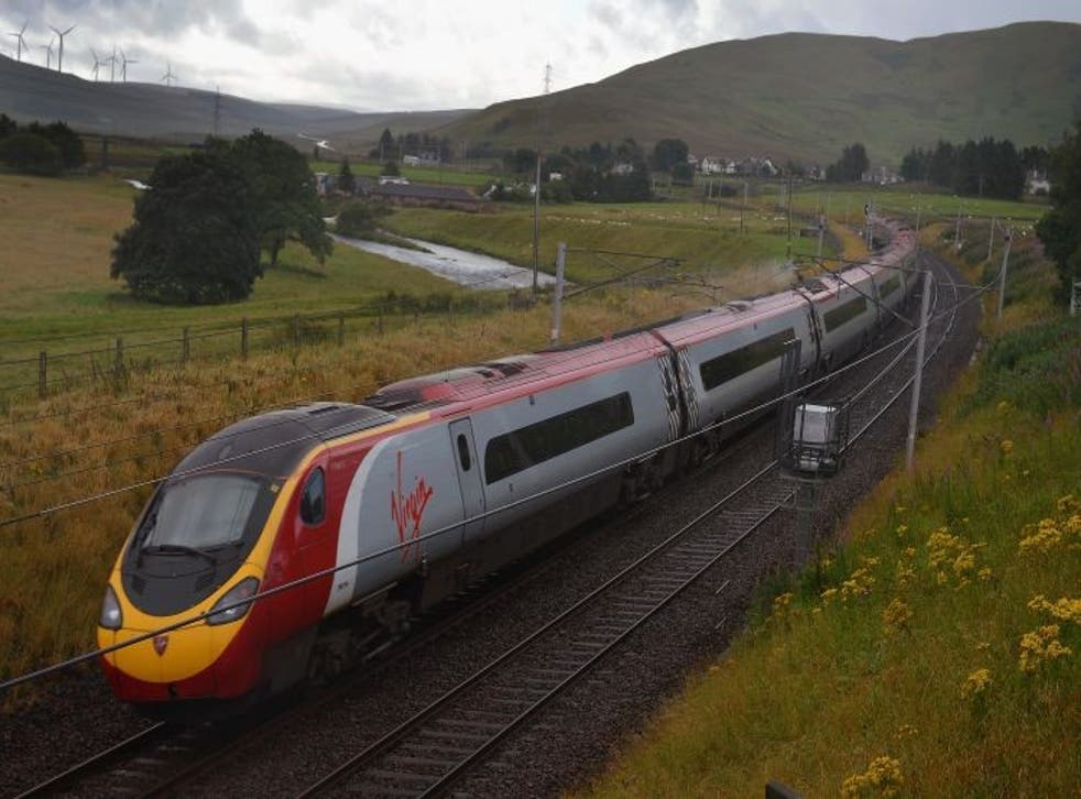 A Virgin train passes along the West Coast mainline route near Abington in Scotland