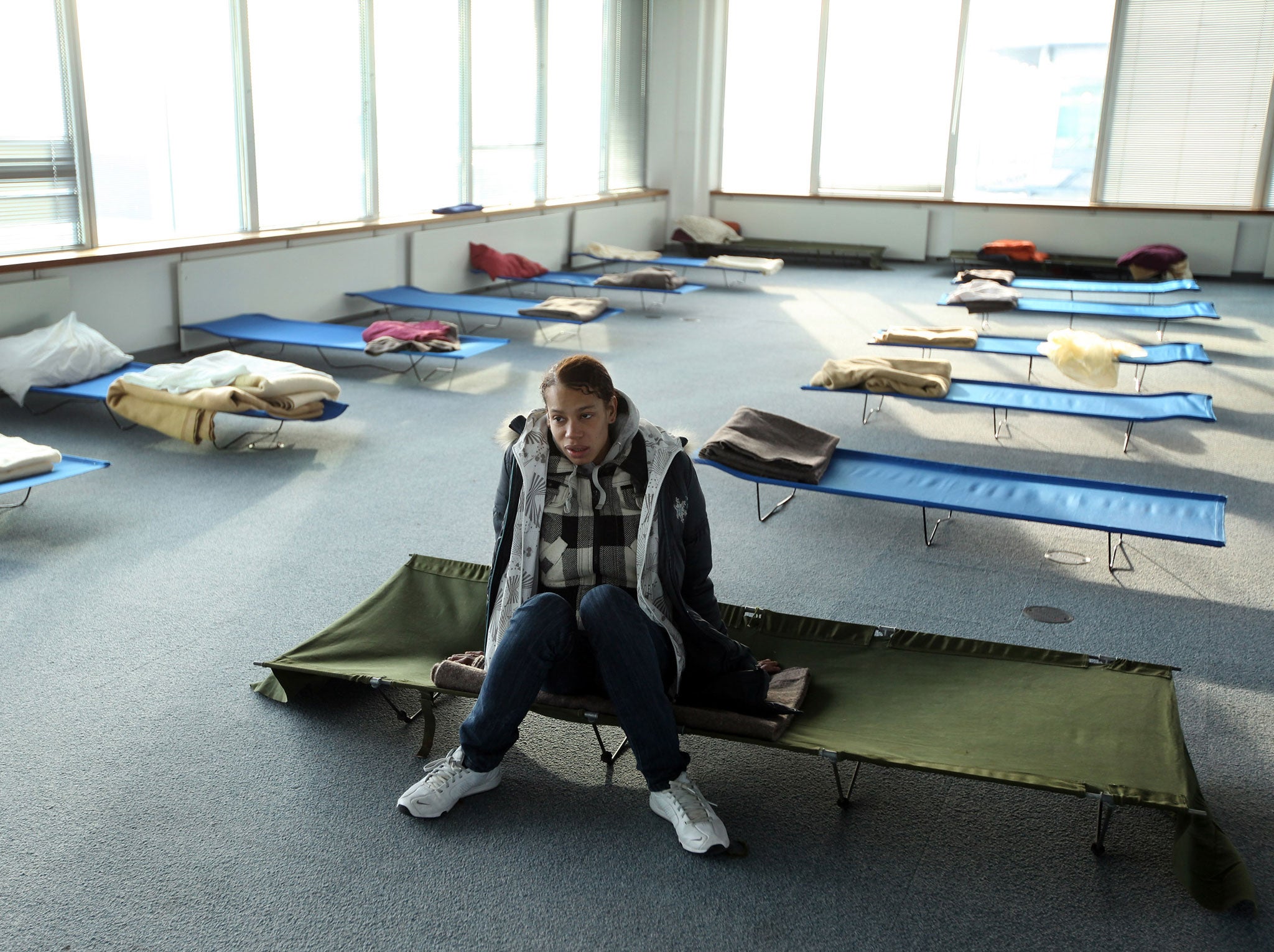 Susan, a homeless woman from London rests on a camp-bed in the dormitory of a Christmas homeless shelter set up by the charity 'Crisis' on December 23, 2009 in London, England.