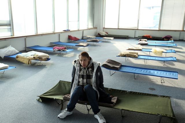 Susan, a homeless woman from London rests on a camp-bed in the dormitory of a Christmas homeless shelter set up by the charity 'Crisis' on December 23, 2009 in London, England.
