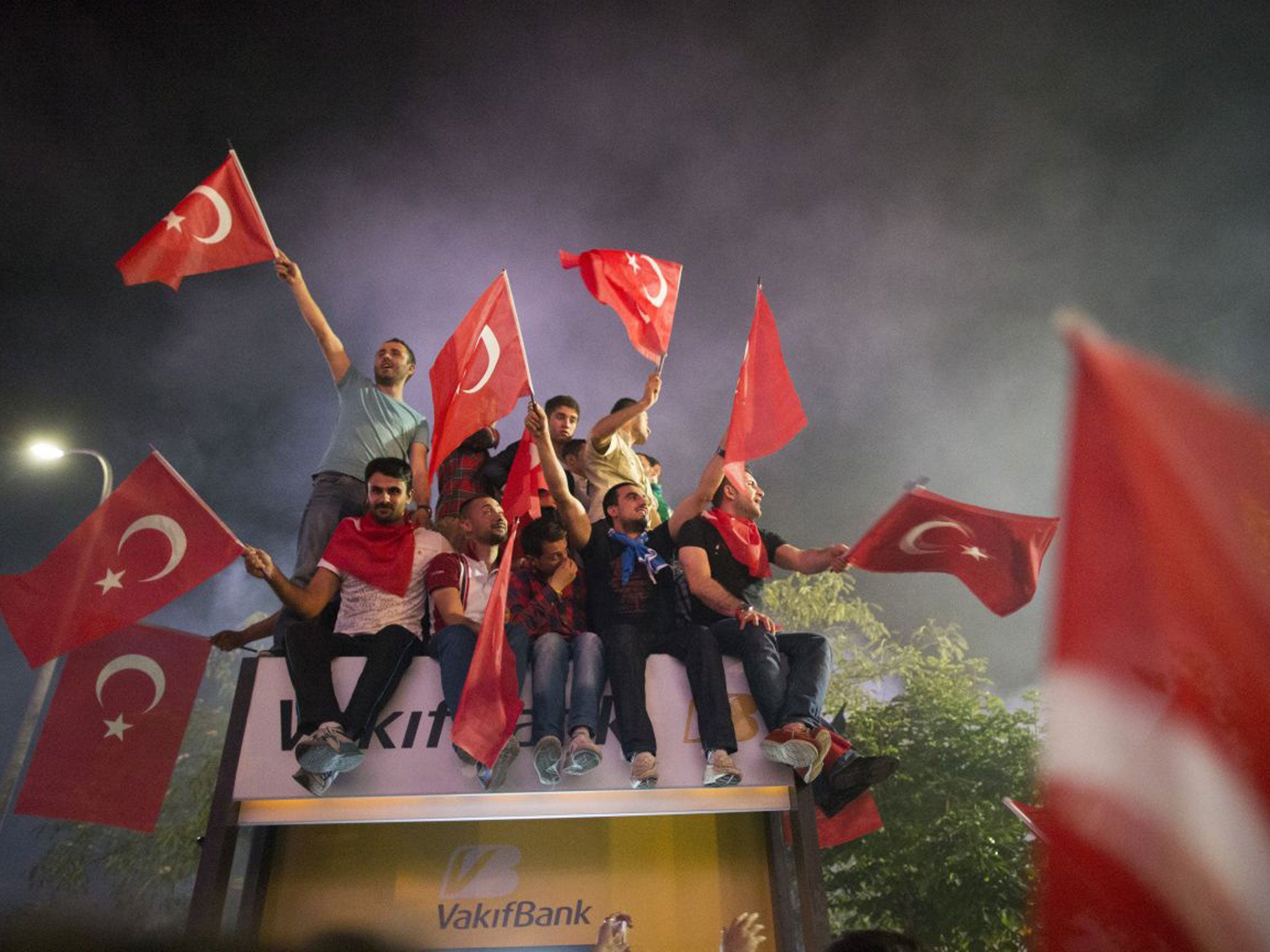Supporters of Prime Minister Recep Tayyip Erdogan greet his return to Istanbul early yesterday