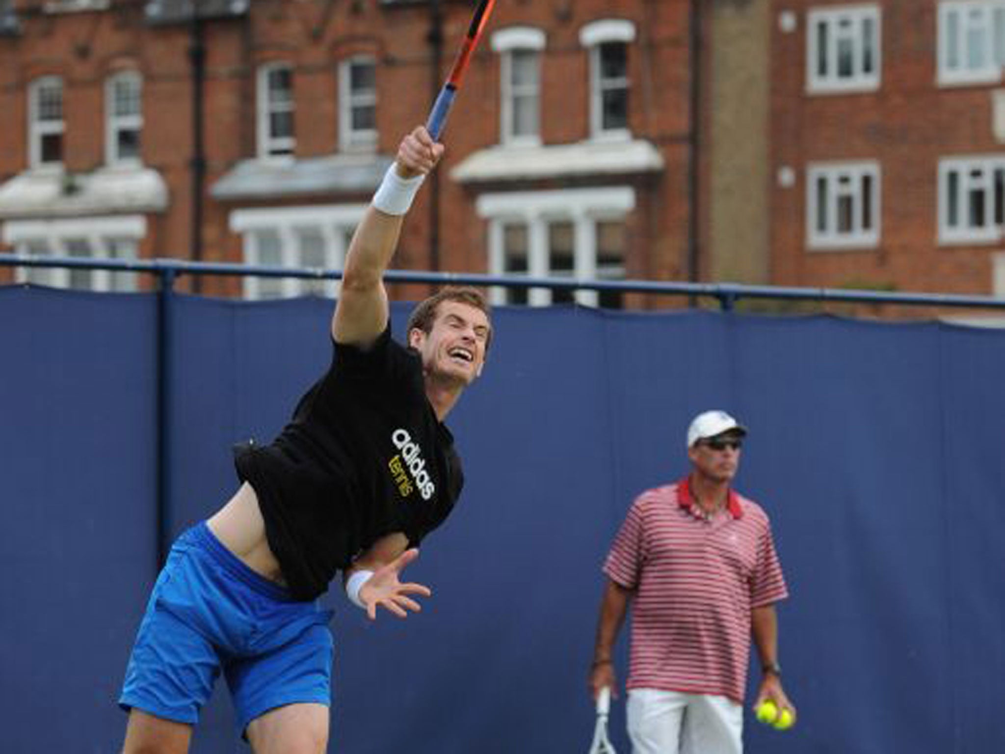 Andy Murray practises serving as coach Ivan Lendl looks on at Queen’s yesterday