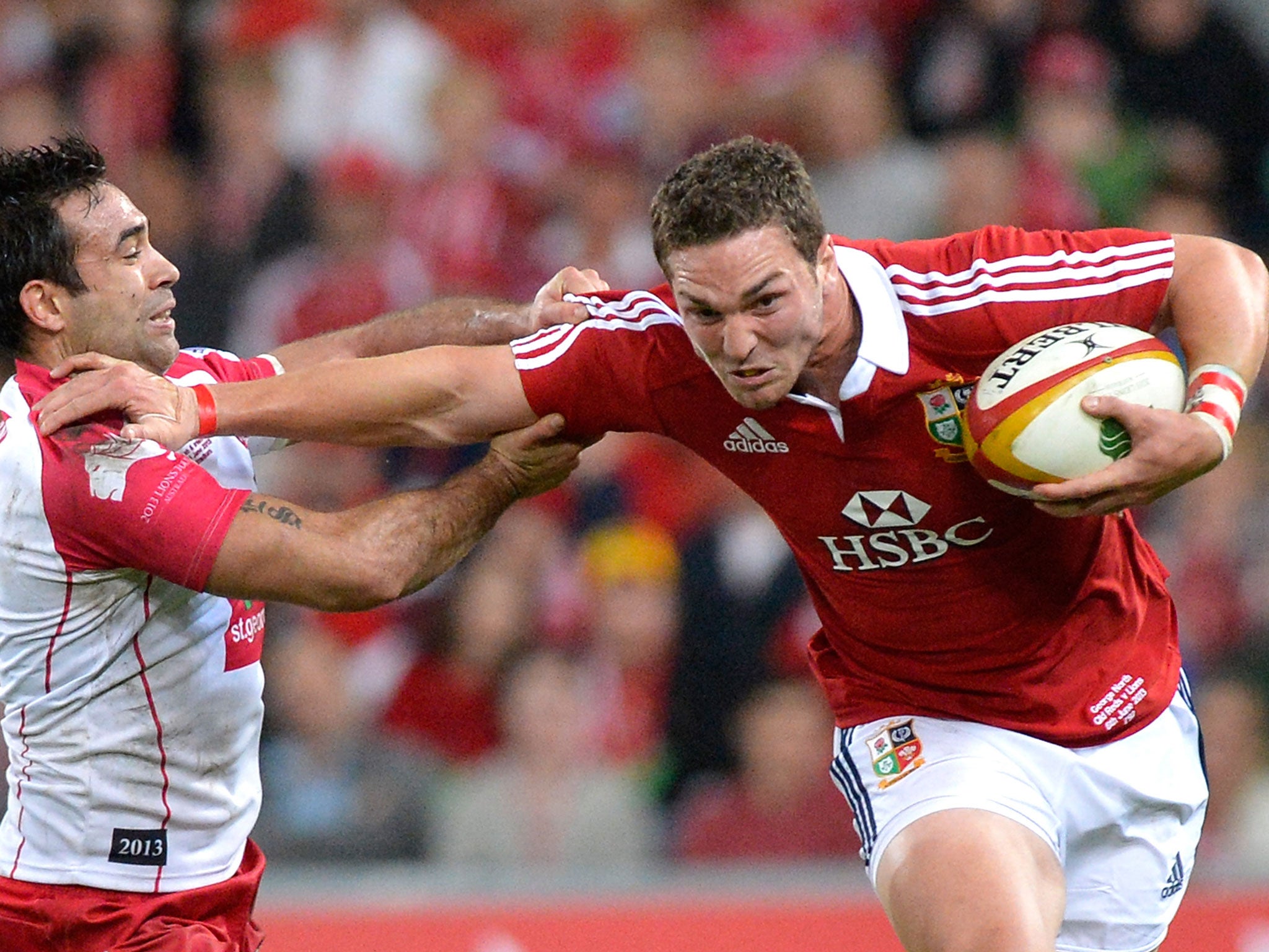 George North of the Lions pushes away from the defence during the match between the Queensland Reds and the British & Irish Lions