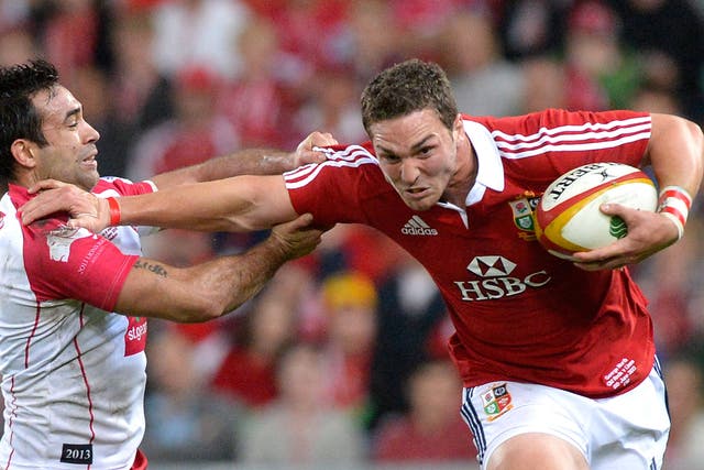 George North of the Lions pushes away from the defence during the match between the Queensland Reds and the British & Irish Lions