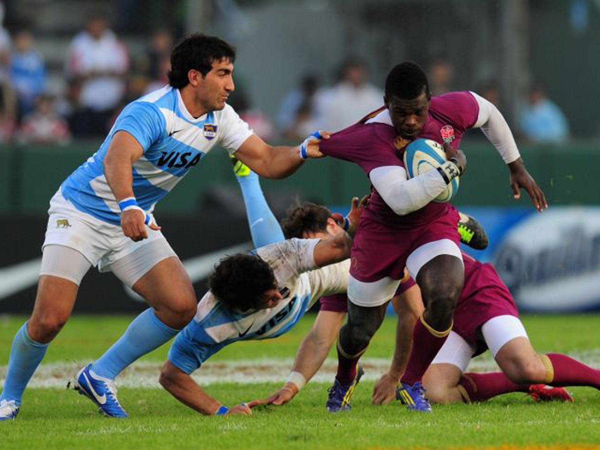 Pulling power: Christian Wade tries to break a Puma tackle on his England debut in Salta last night