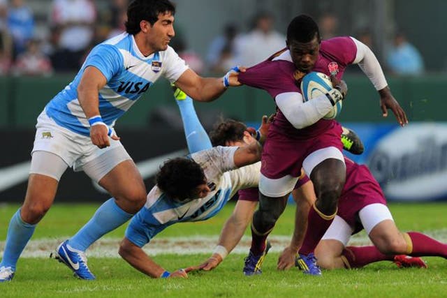 Pulling power: Christian Wade tries to break a Puma tackle on his England debut in Salta last night