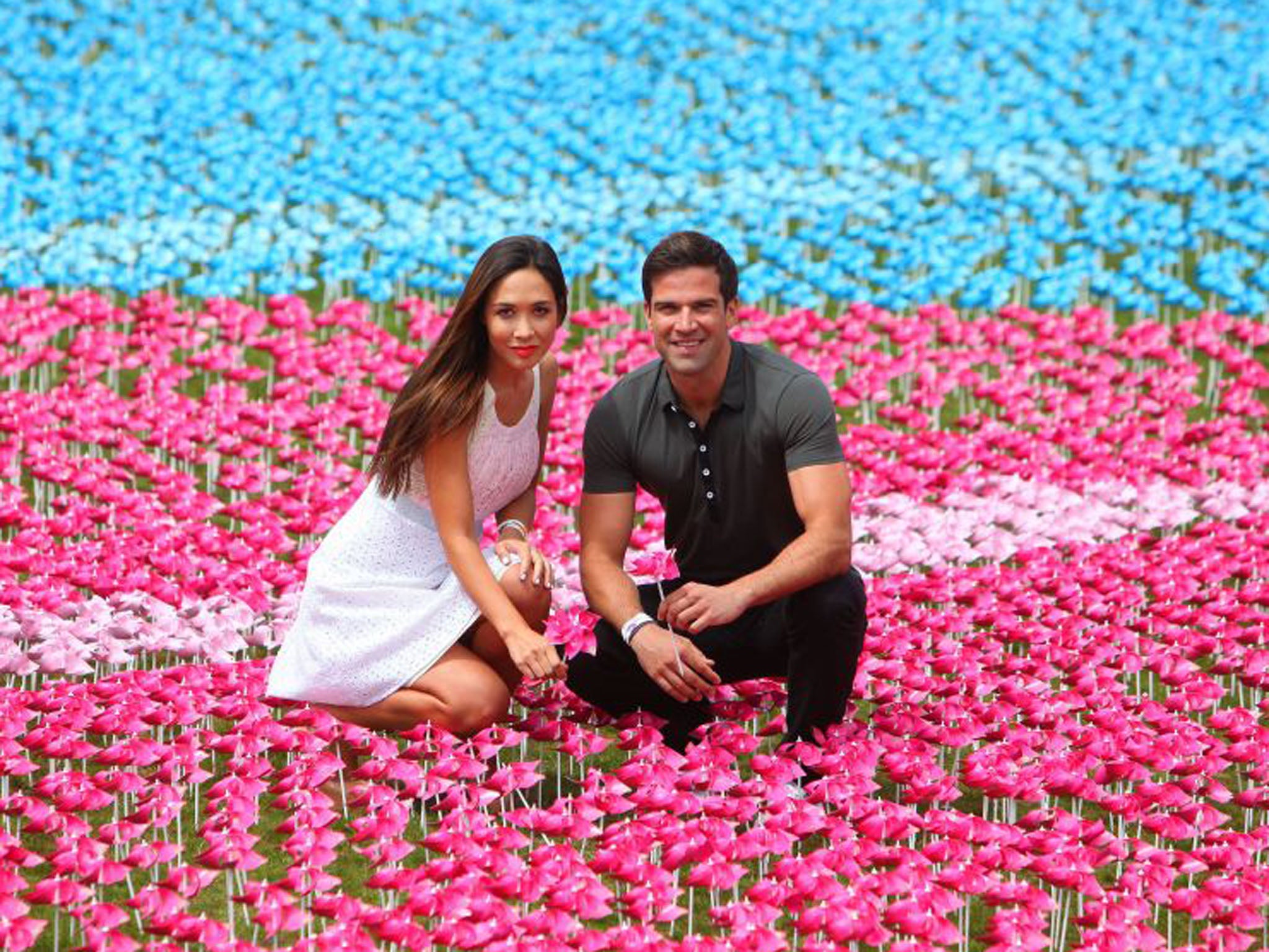 Myleene Klass and Gethin Jones stand within 250,000 spinning flowers  whose petals represent the millions of children who die of hunger every year