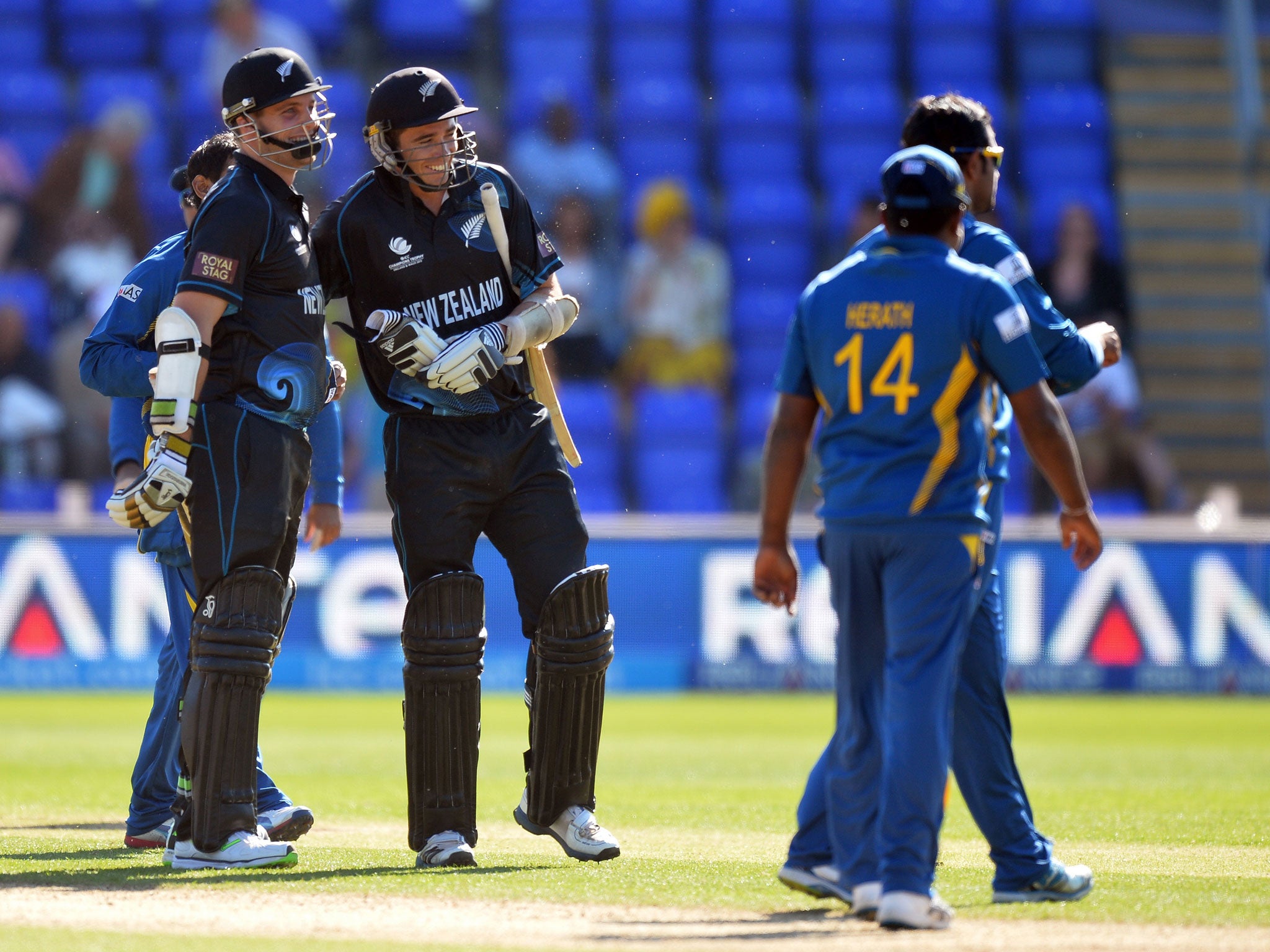 New Zealand's Mitchell McClenaghan (L) and teammate Tim Southee (2-L) celebrate after winning