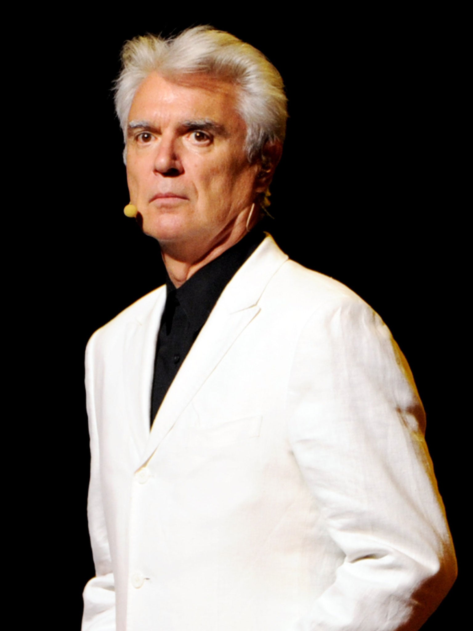 David Byrne took to the stage at Columbia University School of the Arts as a band played his song 'Road to Nowhere'. He then played a slideshow of graphs to illustrate how hopeless arts graduates are