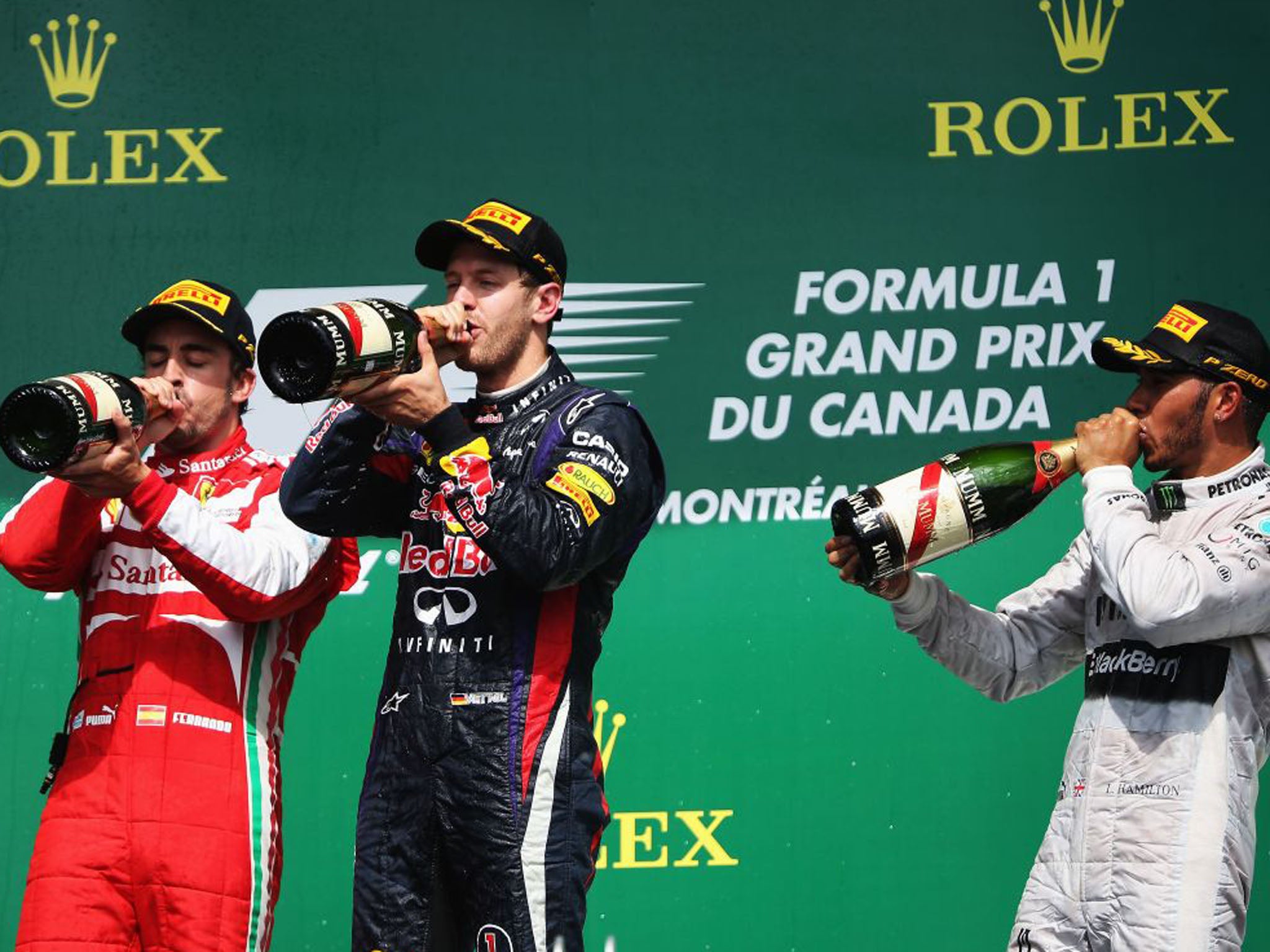 Vettel, centre, Fernando Alonso, left, and Lewis Hamilton on the podium after finishing first, second, and third respectively. The points moved Alonso into second in the championship table (Mark Thompson/Getty Images)