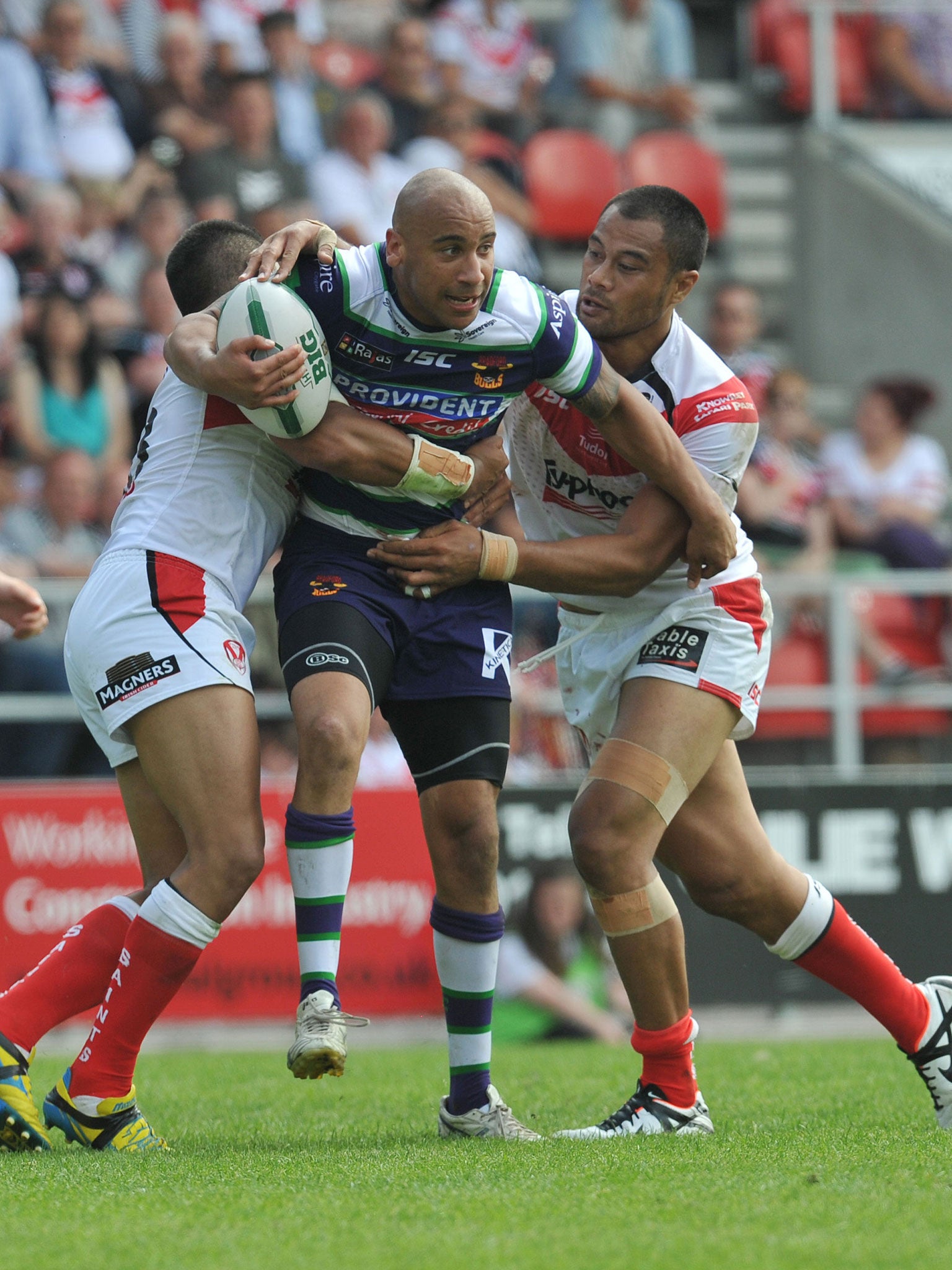Bradford’s Matty Blythe, centre, is tackled by St Helens’ Willie Manu, left, and Tony Puletua, right, as the home team prove to be too strong for the Bulls