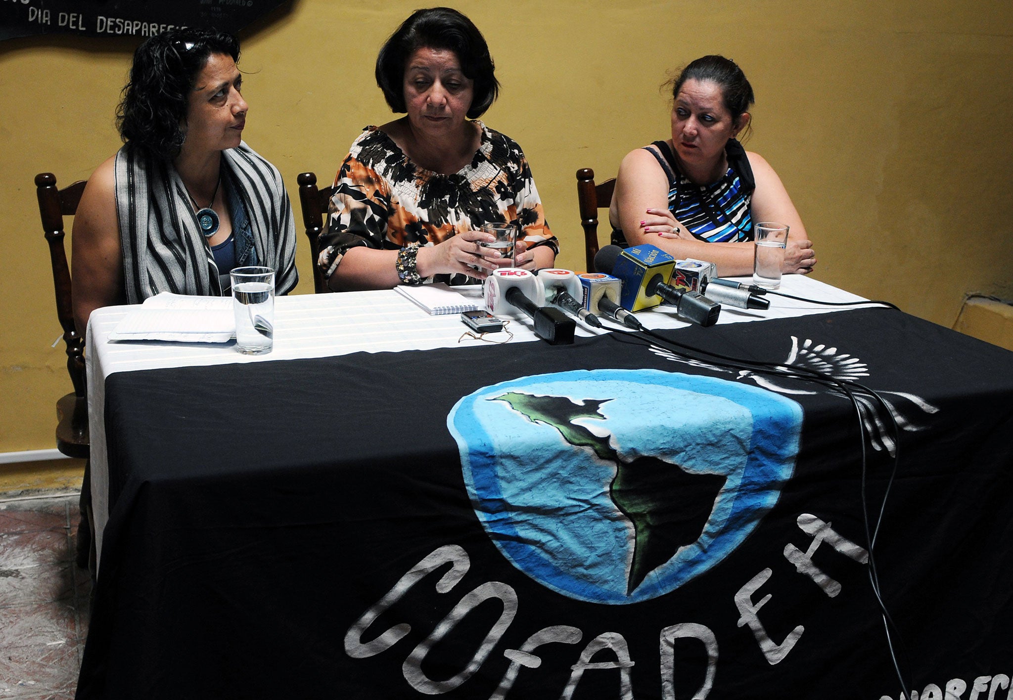 The general coordinator of the Committee of Relatives of Missing Detainees in Honduras (COFADEH), Bertha Oliva (C), speaks flanked by journalist Dina Meza (L)