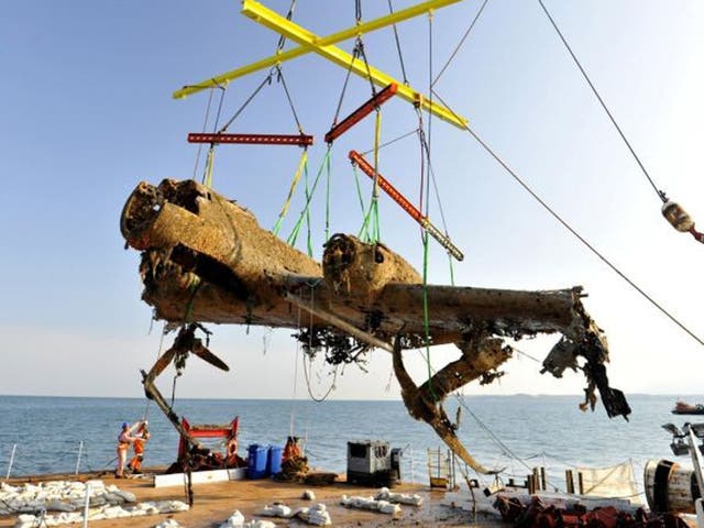 The bomber is raised from the sea by the salvage crew off the coast of Deal