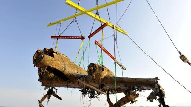 The bomber is raised from the sea by the salvage crew off the coast of Deal
