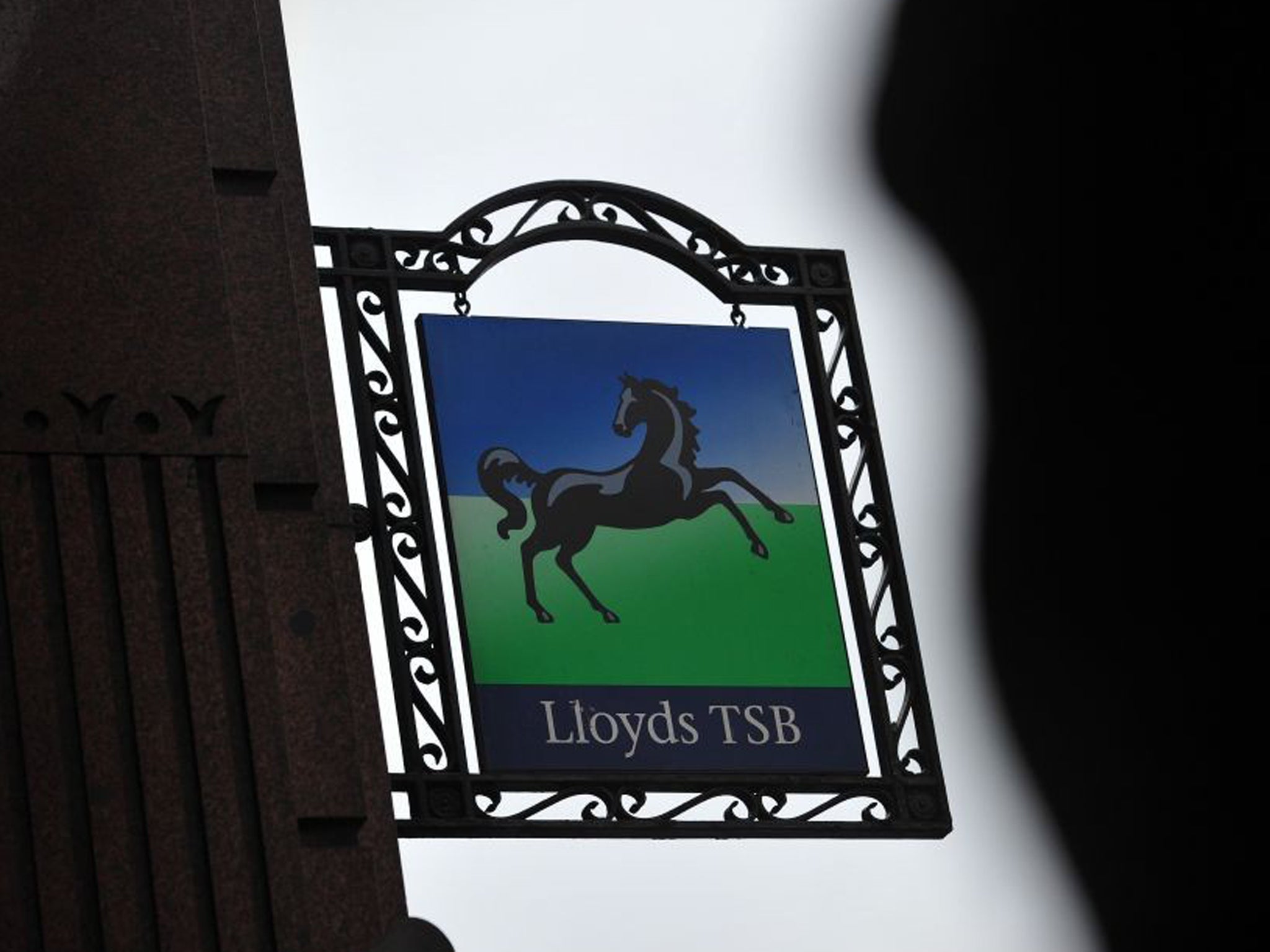Lloyds Banking Group swung out of the red with half-year profits of £2.1bn